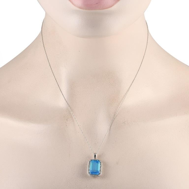 Mark a special occasion with the exquisite beauty of this diamond and blue topaz necklace. The octagonal pendant measures 1 by 0.50 and has a frame of petite round diamonds. Sitting prominently at the center is a dazzling blue topaz. A spring ring