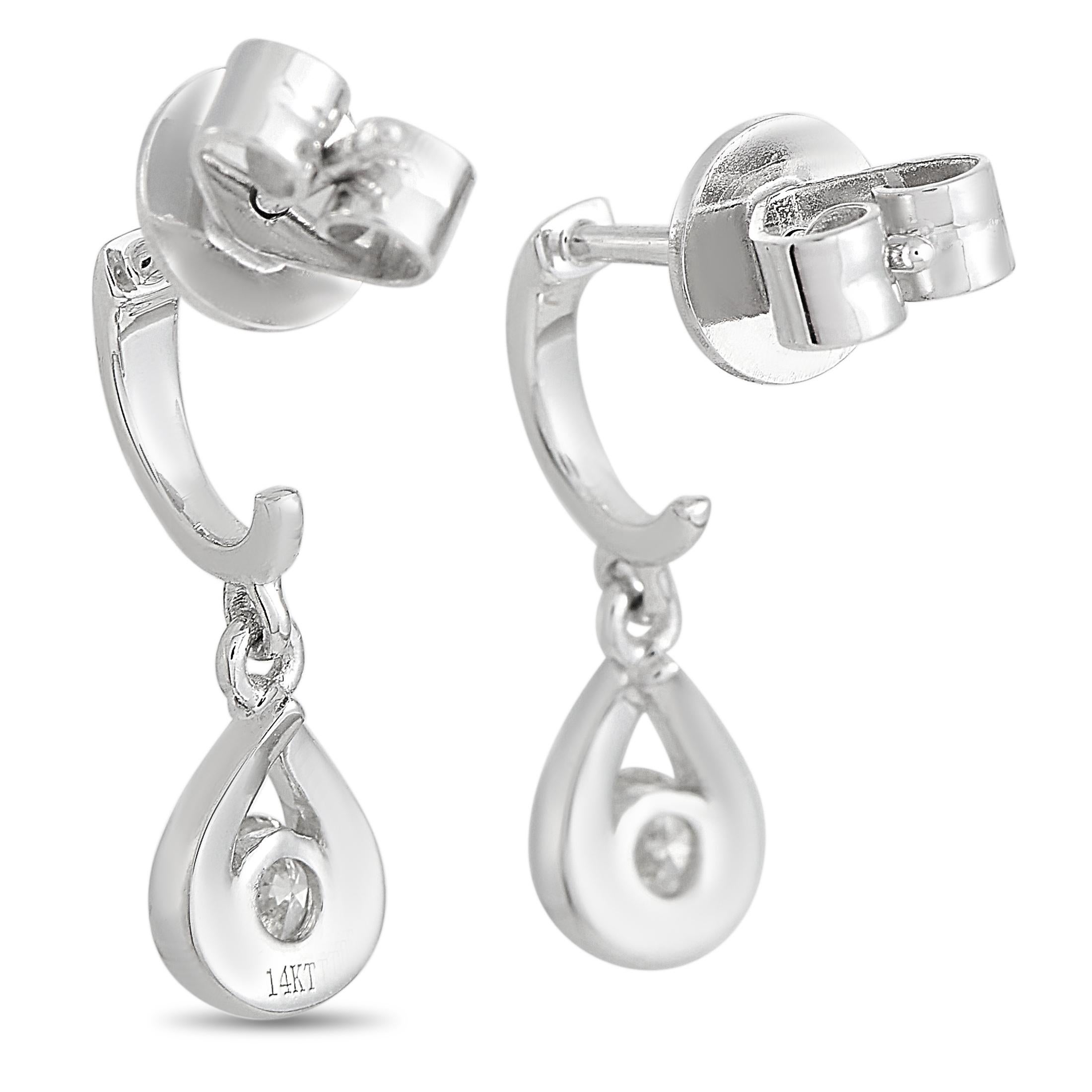 These LB Exclusive earrings are crafted from 14K white gold and each of the two weighs 0.95 grams. They measure 0.65” in length and 0.25” in width. The pair is set with diamonds that total 0.20 carats.
 
 The earrings are offered in brand new