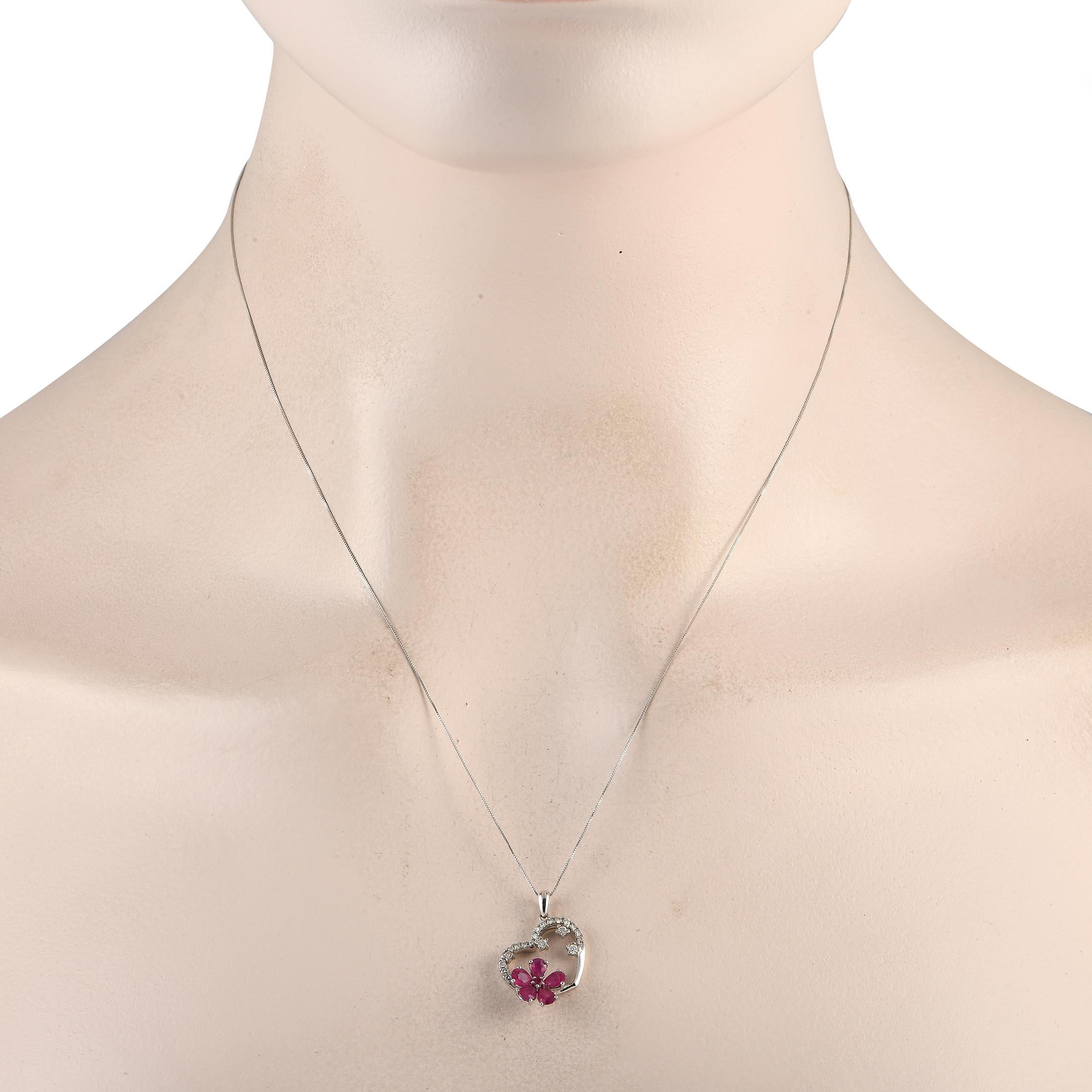 A heart-shaped pendant measuring 0.85 long by 0.65 wide makes this 14K White Gold necklace instantly captivating. Sweet and sophisticated, it comes complete with Ruby gemstones in a floral motif, sparkling Diamonds totaling 0.20 carats, and a sleek