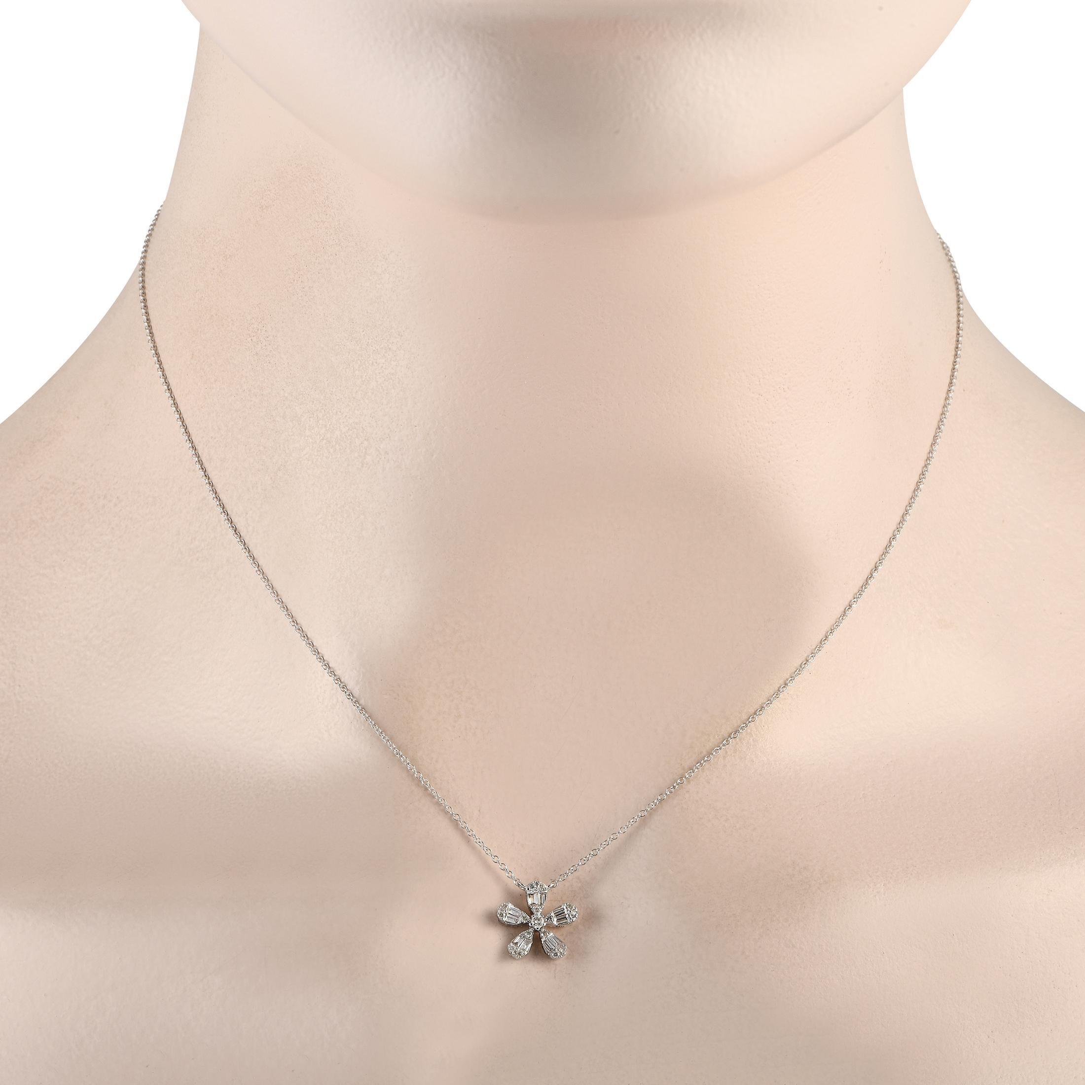 A dainty floral shaped pendant measuring 0.45 round makes a statement thanks to inset diamonds totaling 0.23 carats on this charming necklace. This elegant accessory is crafted from 14K white gold and features a delicate chain measuring 16 long.This