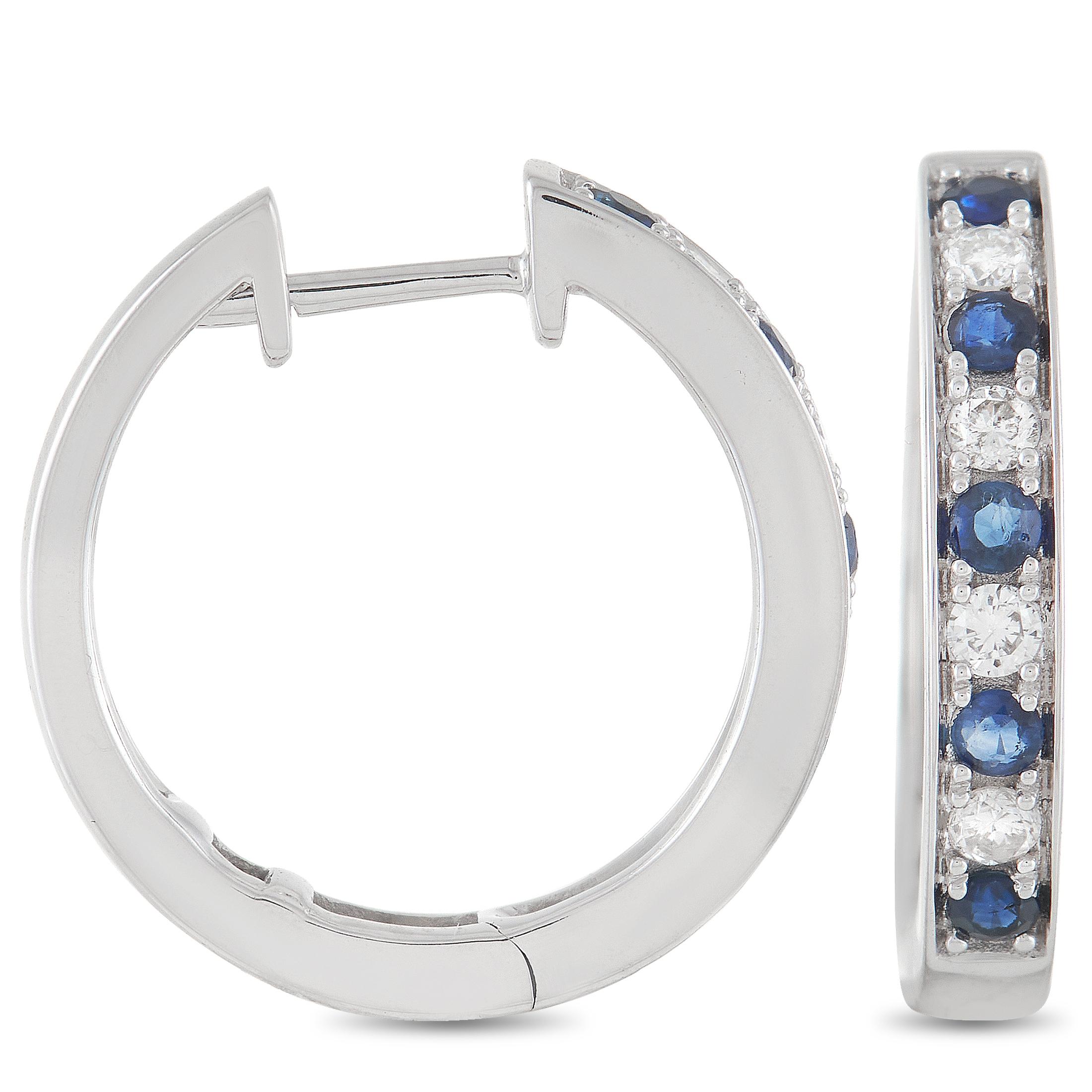 These stunning LB Exclusive 14K White Gold 0.25 ct Diamond 0.42 ct Sapphire Hoop Earrings are made with 14K white gold and are set with 0.25 carats of round-cut diamonds and 0.42 carats of round cut sapphires set in a single row along the face of