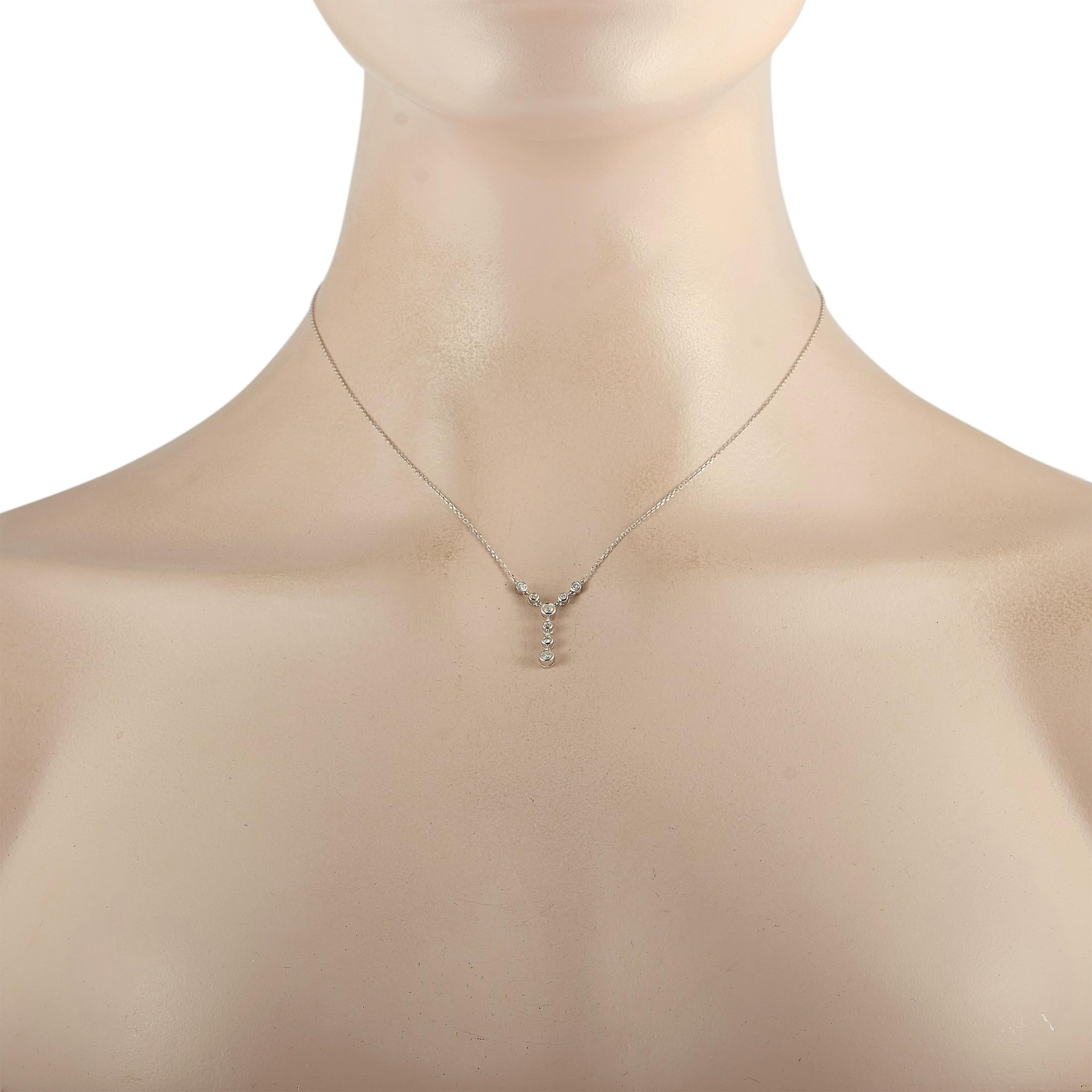 This LB Exclusive necklace is crafted from 14K white gold and weighs 2.1 grams. It is presented with a 15” chain and a pendant that measures 0.62” in length and 0.12” in width. The necklace is embellished with diamonds that total 0.25 carats.
 
