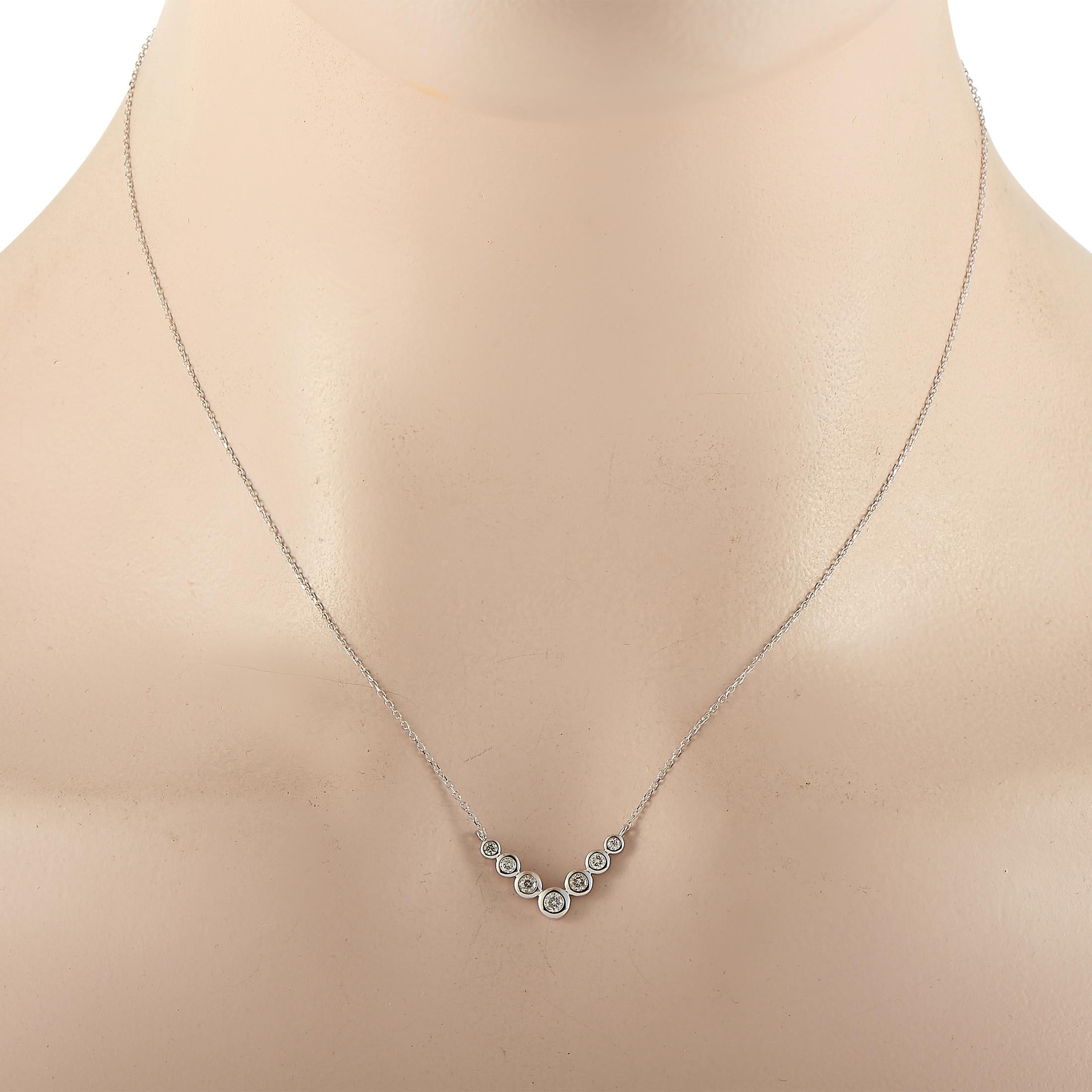 This LB Exclusive necklace is crafted from 14K white gold and weighs 2 grams. It is presented with a 16” chain and boasts a pendant that measures 0.50” in length and 0.75” in width. The necklace is set with diamonds that total 0.25 carats.
 
