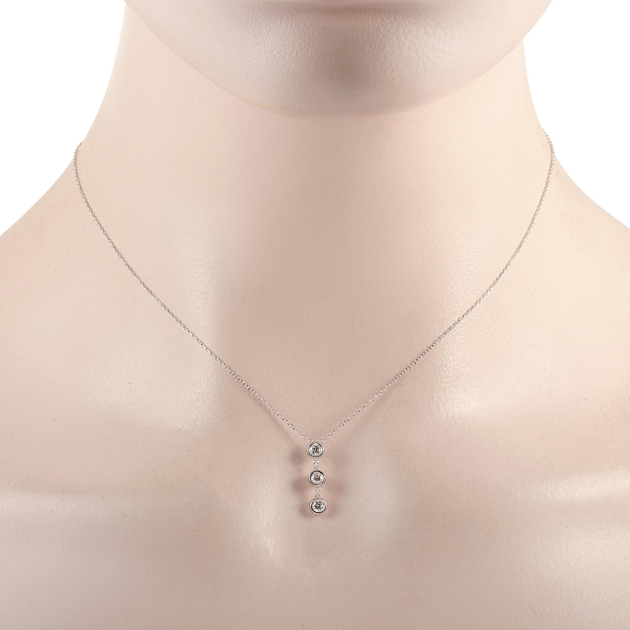 This LB Exclusive necklace is crafted from 14K white gold and weighs 1.6 grams. It is presented with a 15” chain and boasts a pendant that measures 0.63” in length and 0.13” in width. The necklace is set with diamonds that total 0.25 carats.
 
