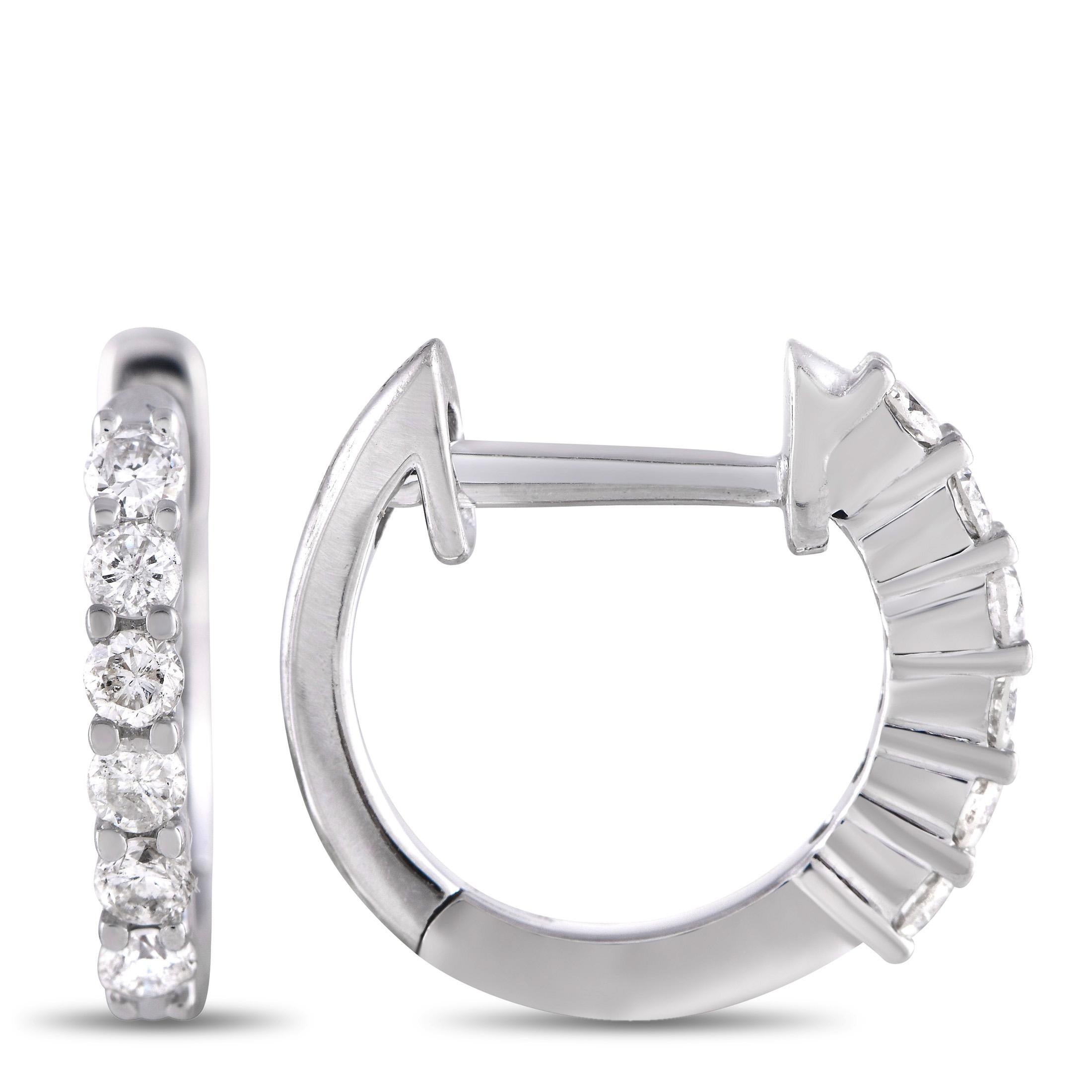 Round-cut diamonds totaling 0.25 carats add the perfect amount of sparkle to these delicate hoop earrings. A shimmering 14K White Gold setting measuring 0.5” round beautifully complements the glittering gemstones, which make a statement at the