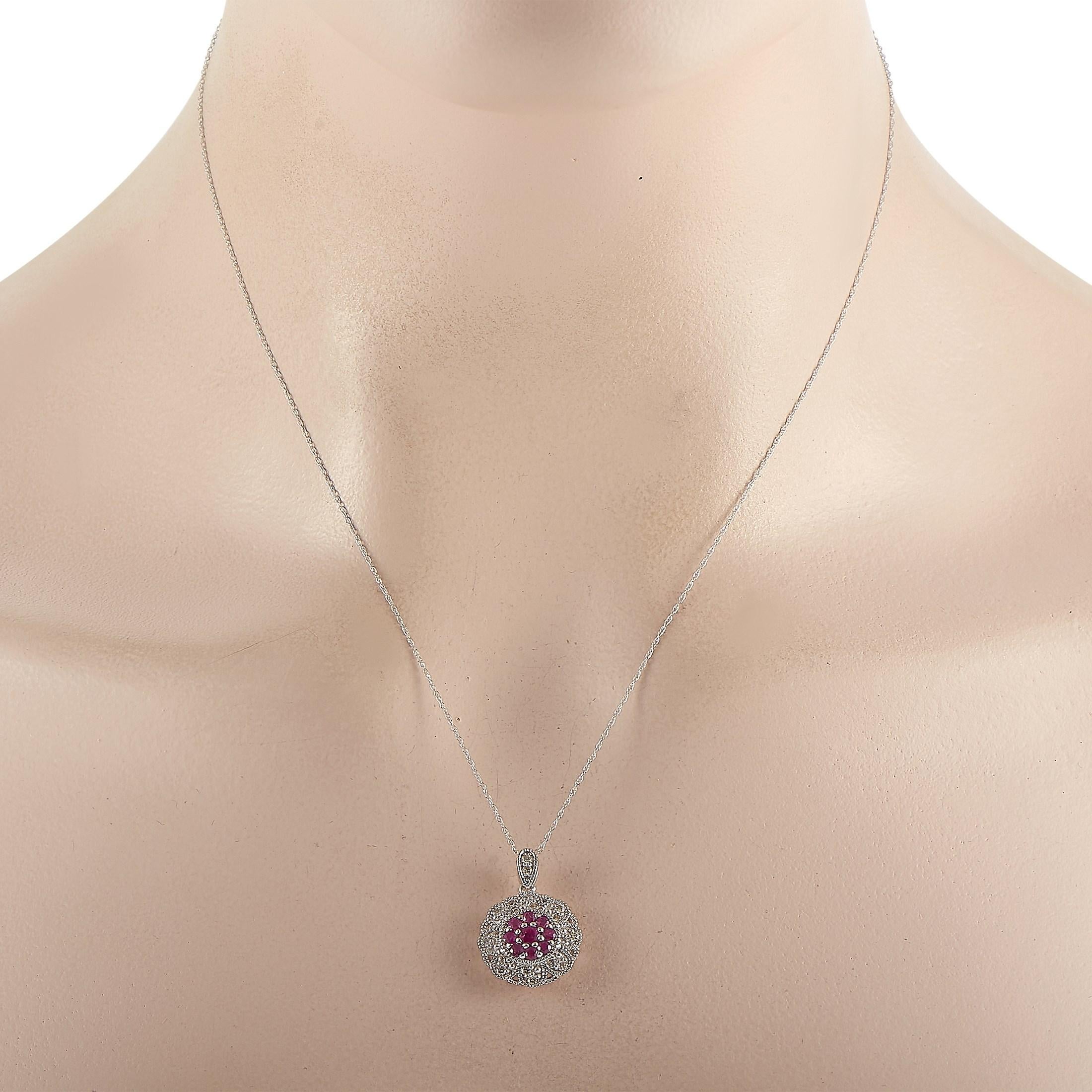 This LB Exclusive 14K White Gold 0.27 ct Diamond and Ruby Round Pendant Necklace features a delicate 14K White Gold chain measuring 18 inches in length. The necklace features a round pendant set with 0.27 carats of round-cut diamonds around 9