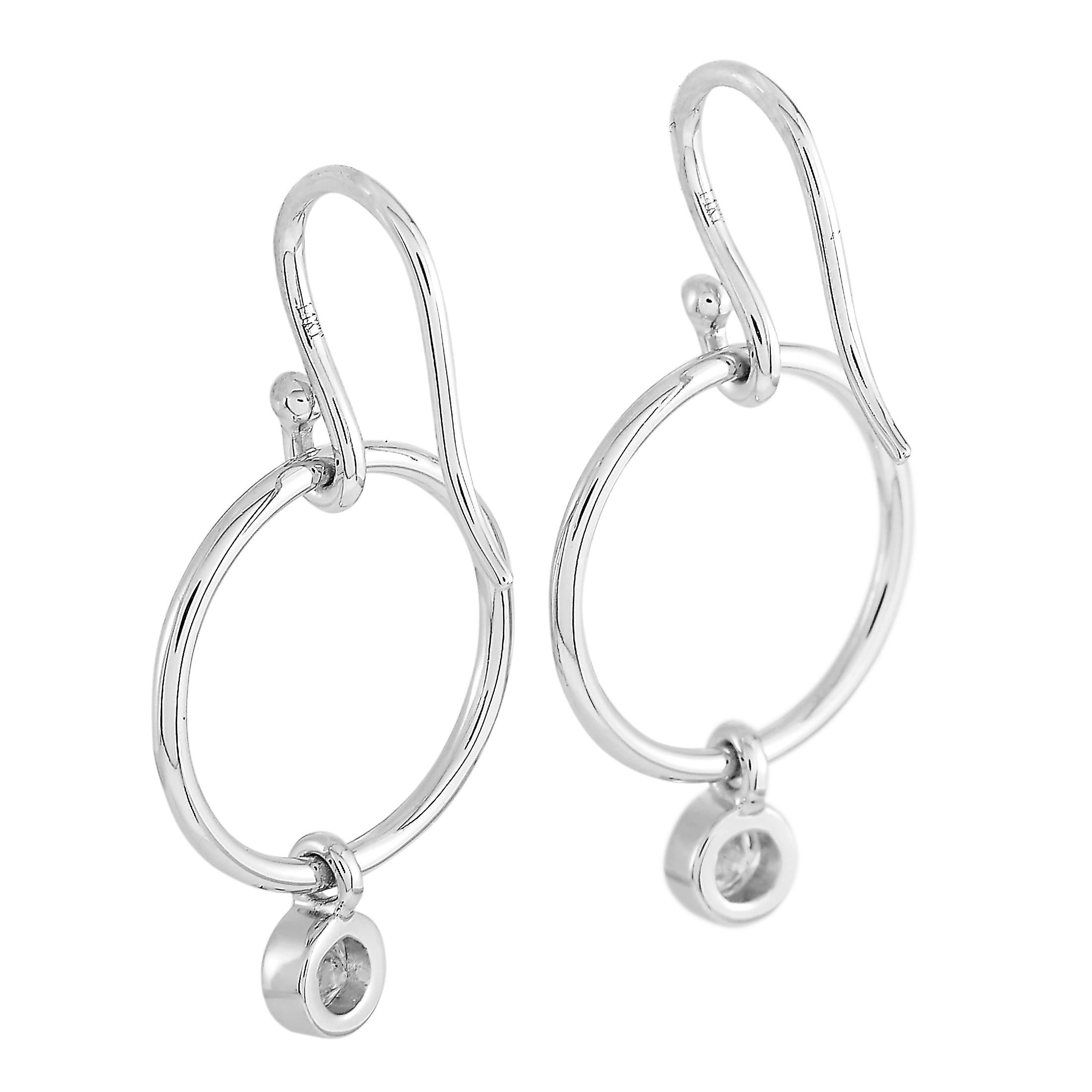 These LB Exclusive earrings are made of 14K white gold and embellished with diamonds that total 0.32 carats. The earrings measure 1.25” in length and 0.65” in width and each of the two weighs 1.4 grams.
 
 The pair is offered in brand new condition