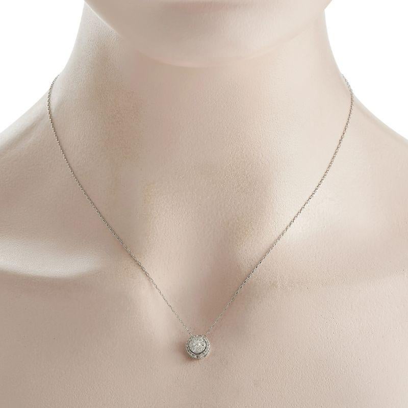 You can never go wrong with the casual elegance of this diamond necklace. The 17-inch-long dainty chain holds a round pendant with a circular cluster of round diamonds on its center, surrounded by a halo of more round diamonds. The pendant measures