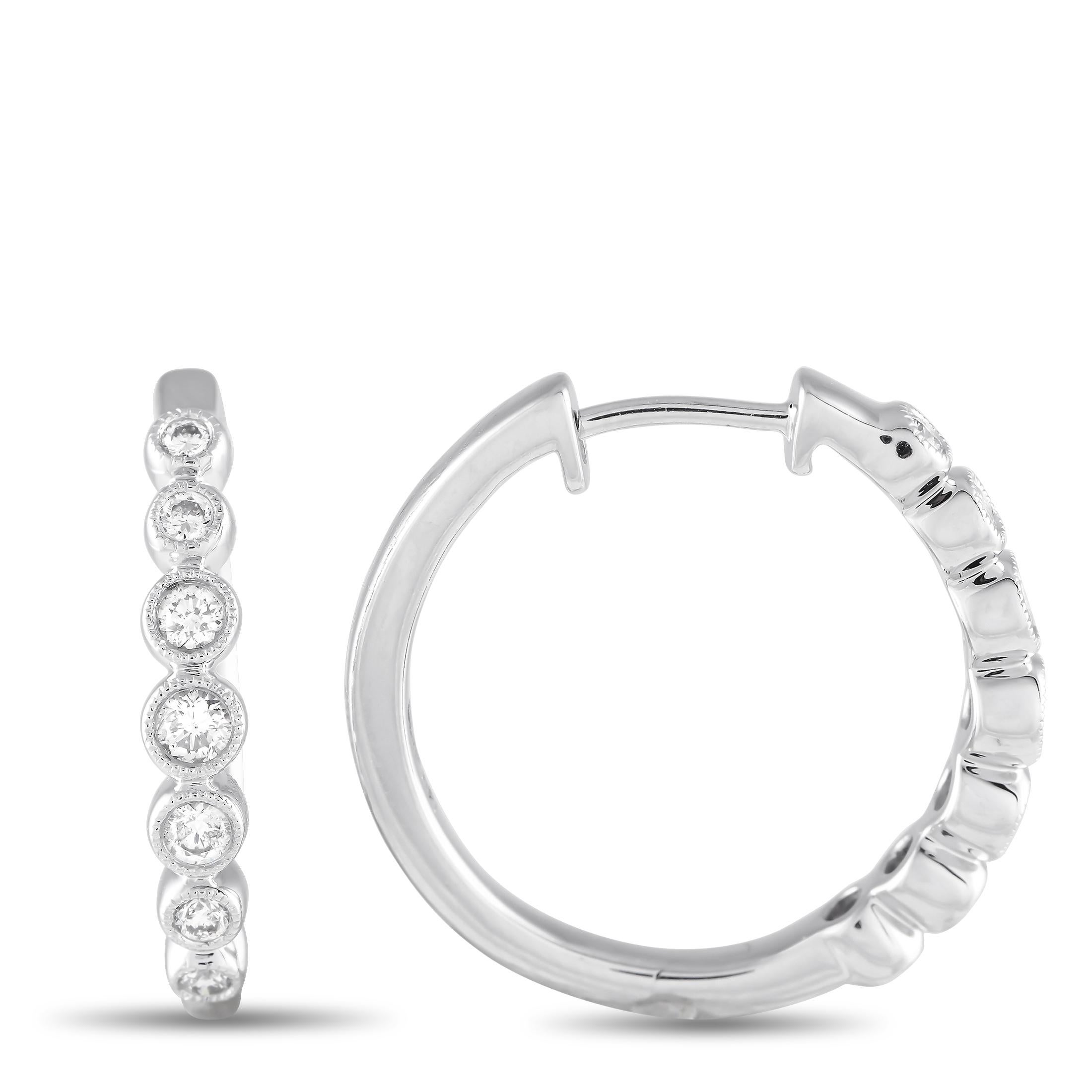 A series of bezel-set Diamonds with a total weight of 0.50 carats make these impeccably crafted hoop earrings unlike anything youve seen before. A contemporary take on a classic accessory, each one measures 0.85 round and features a setting made