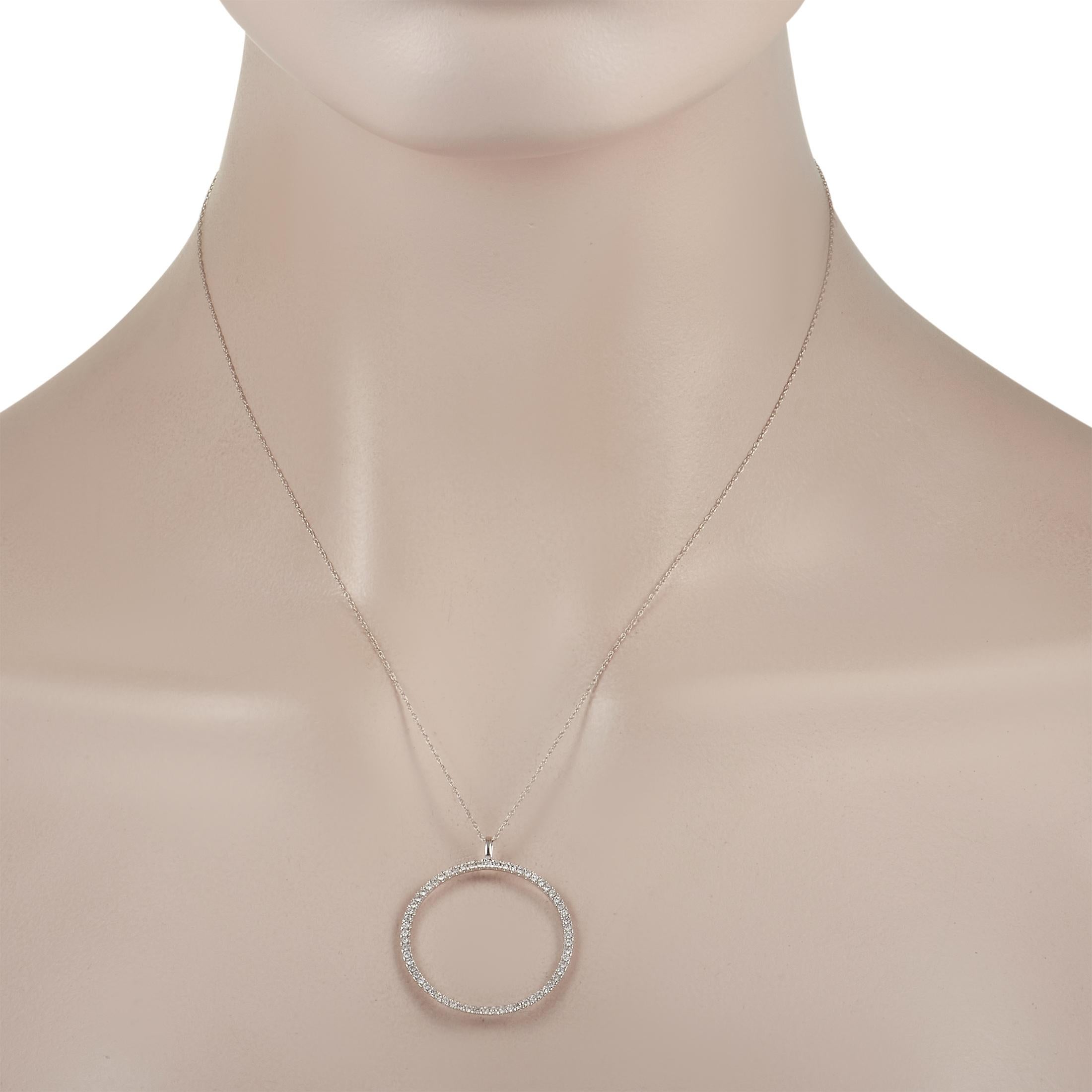 This elegant 14K White Gold necklace is sleek, simple piece with an obvious sense of sophistication. The stylish circular pendant measures 1.25” long, 1.15” wide, and comes suspended from an 18” chain. It’s also completely covered in diamonds, which