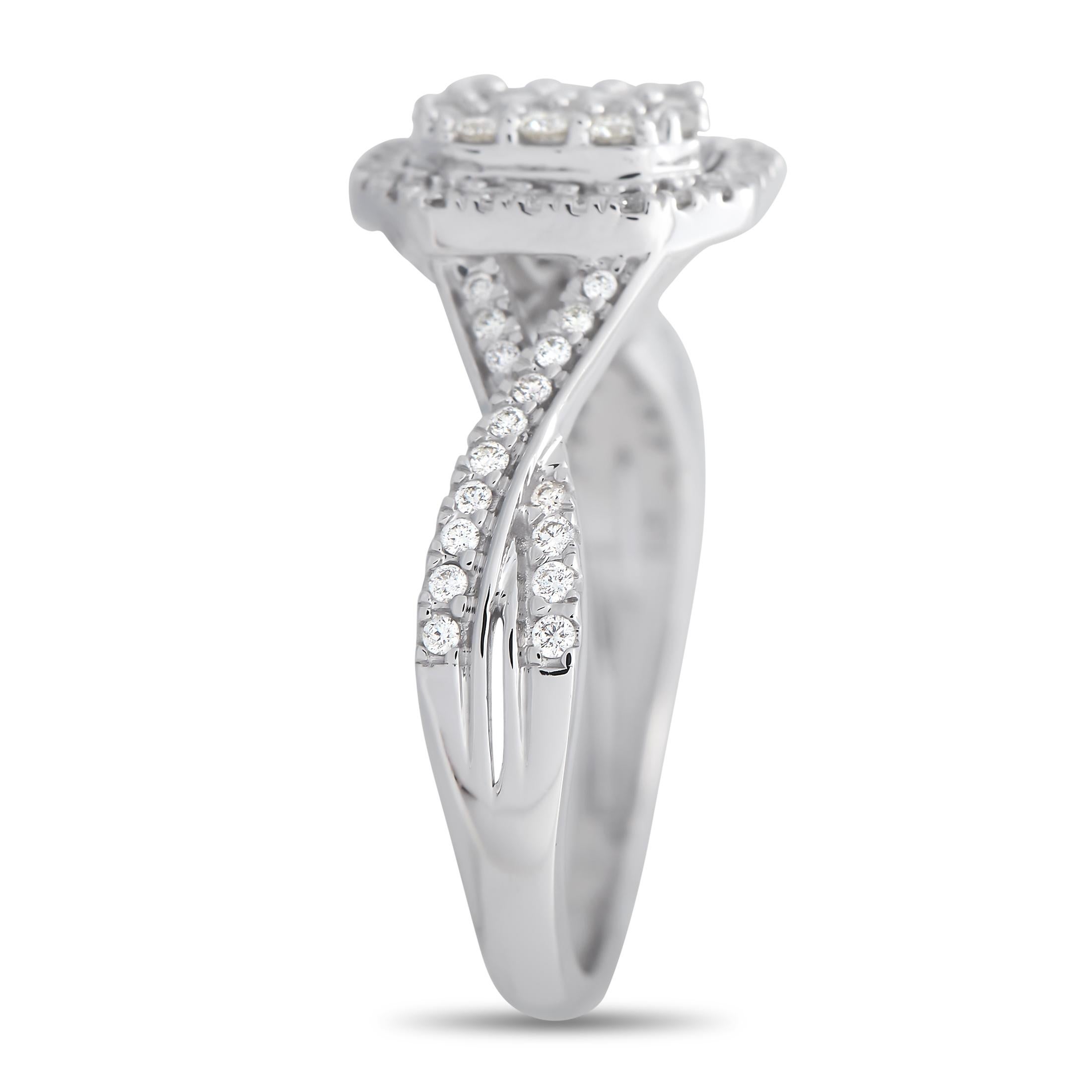 This is a ring of pure elegance. It features a diamond-traced twisted shank topped with a mesmerizing diamond cluster centerpiece. The sparkling group of diamonds is further framed by an octagonal halo of smaller diamonds. The band measures 3mm