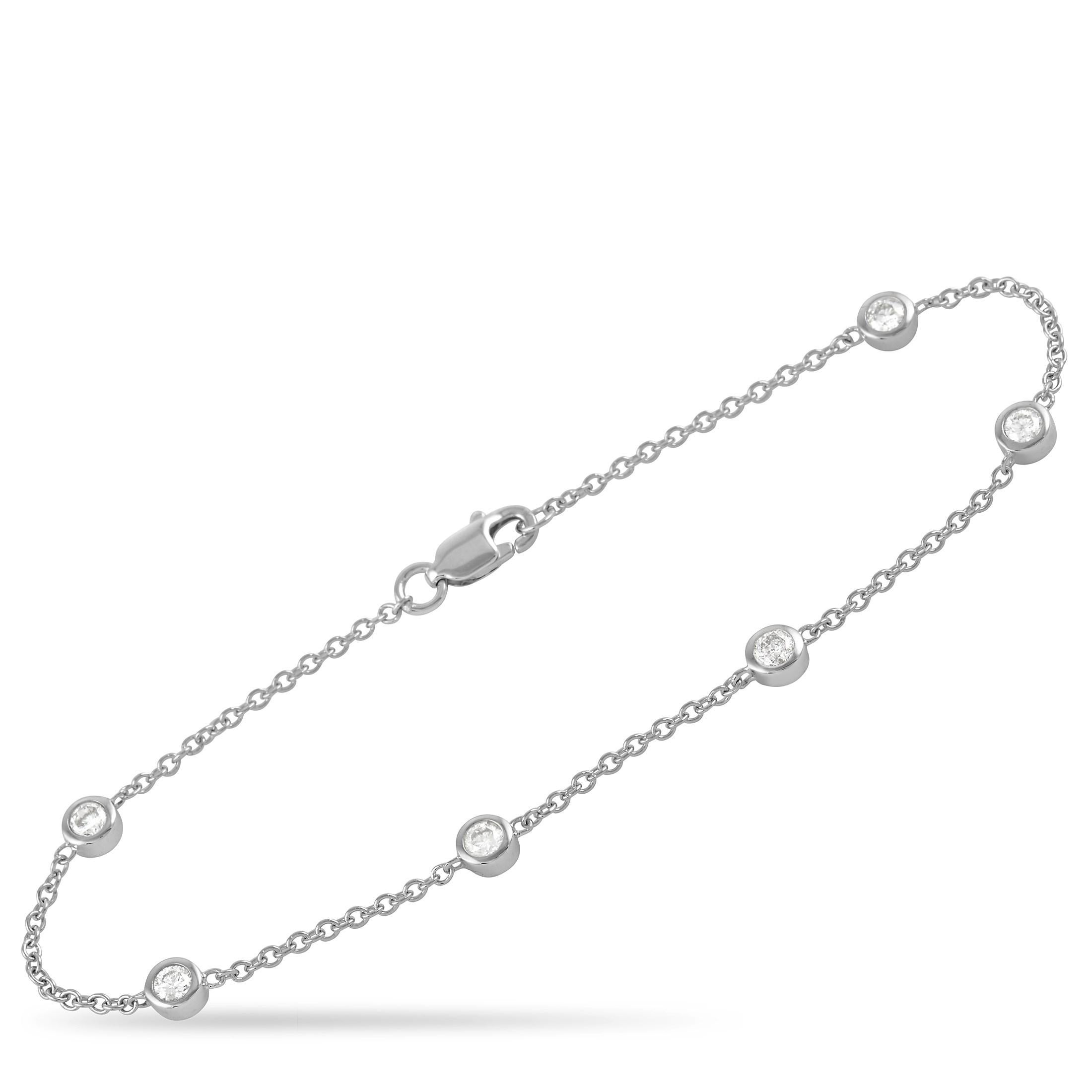 Diamonds with a total weight of 0.55 carats in a sleek bezel setting make this elegant piece truly come alive. Made from 14K White Gold, this bracelet measures 7” long and comes complete with secure lobster clasp closure. 

This jewelry piece is