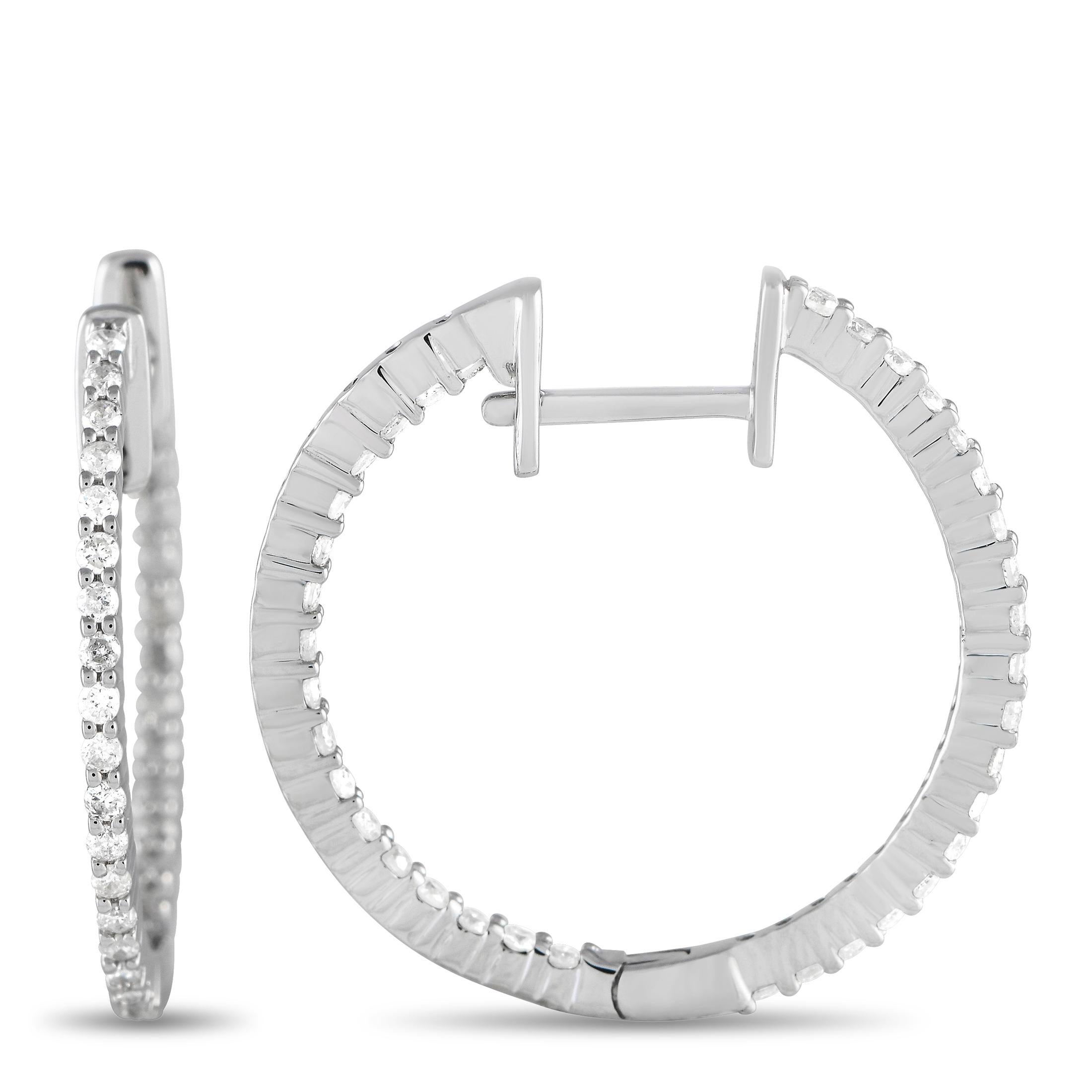 These delicate hoop earrings will beautifully complement any ensemble. Each one features a simple 14K White Gold setting measuring 0.80” round. Sparkling diamonds with a total weight of 0.55 carats allow them to effortlessly catch the light. 

This