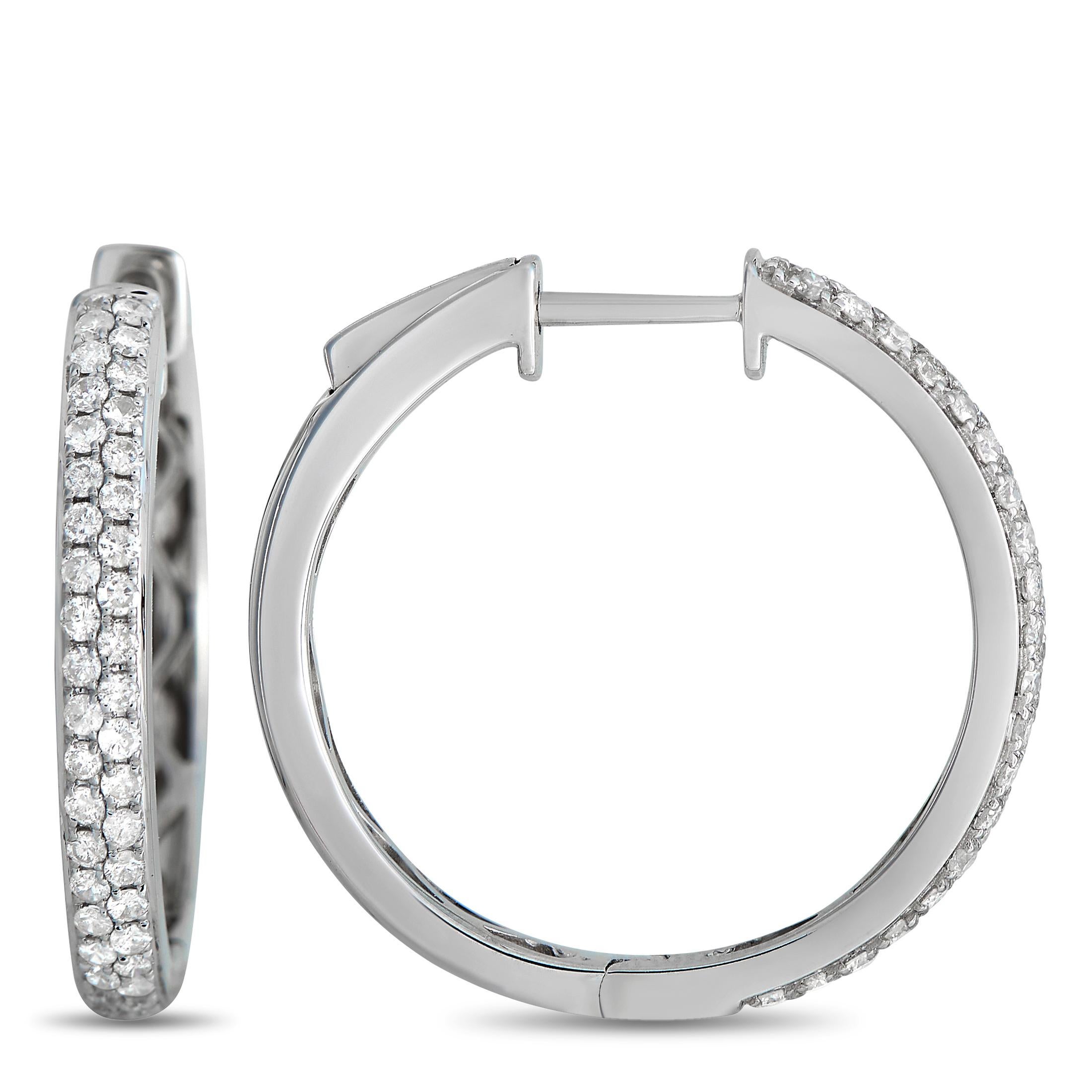 Add a touch of sparkle to any ensemble with the help of these elegant hoop earrings. Each one features an intricate 14K White Gold setting that measures 0.75” round. Diamonds with a total weight of 0.65 carats make them simply unforgettable. 

This