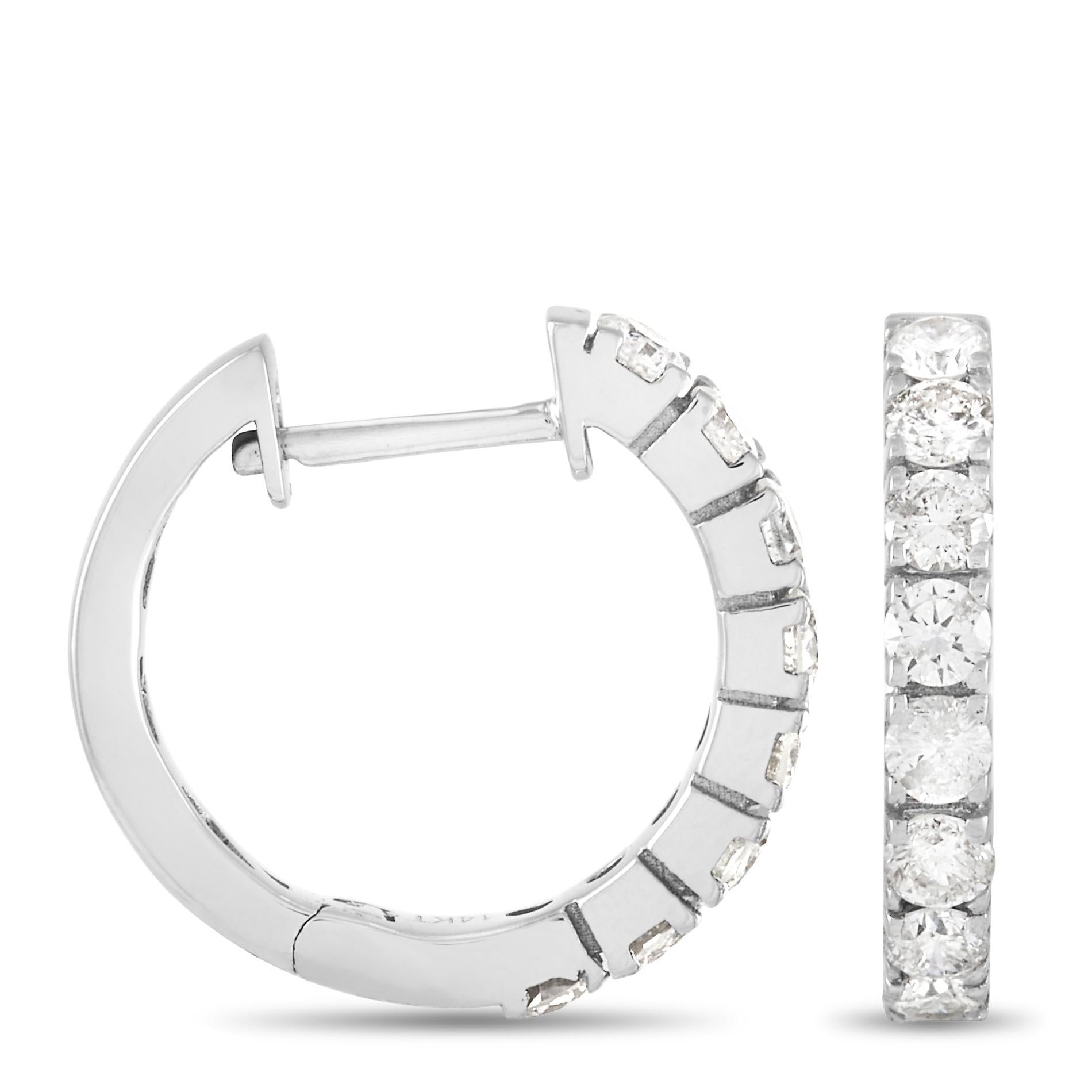 On this classic design, glittering diamonds and shimmering 14K White Gold come together to create a breathtaking pair of hoop earrings. These earrings shine to life thanks to the series of inset, round-cut diamonds with a total weight of 0.83