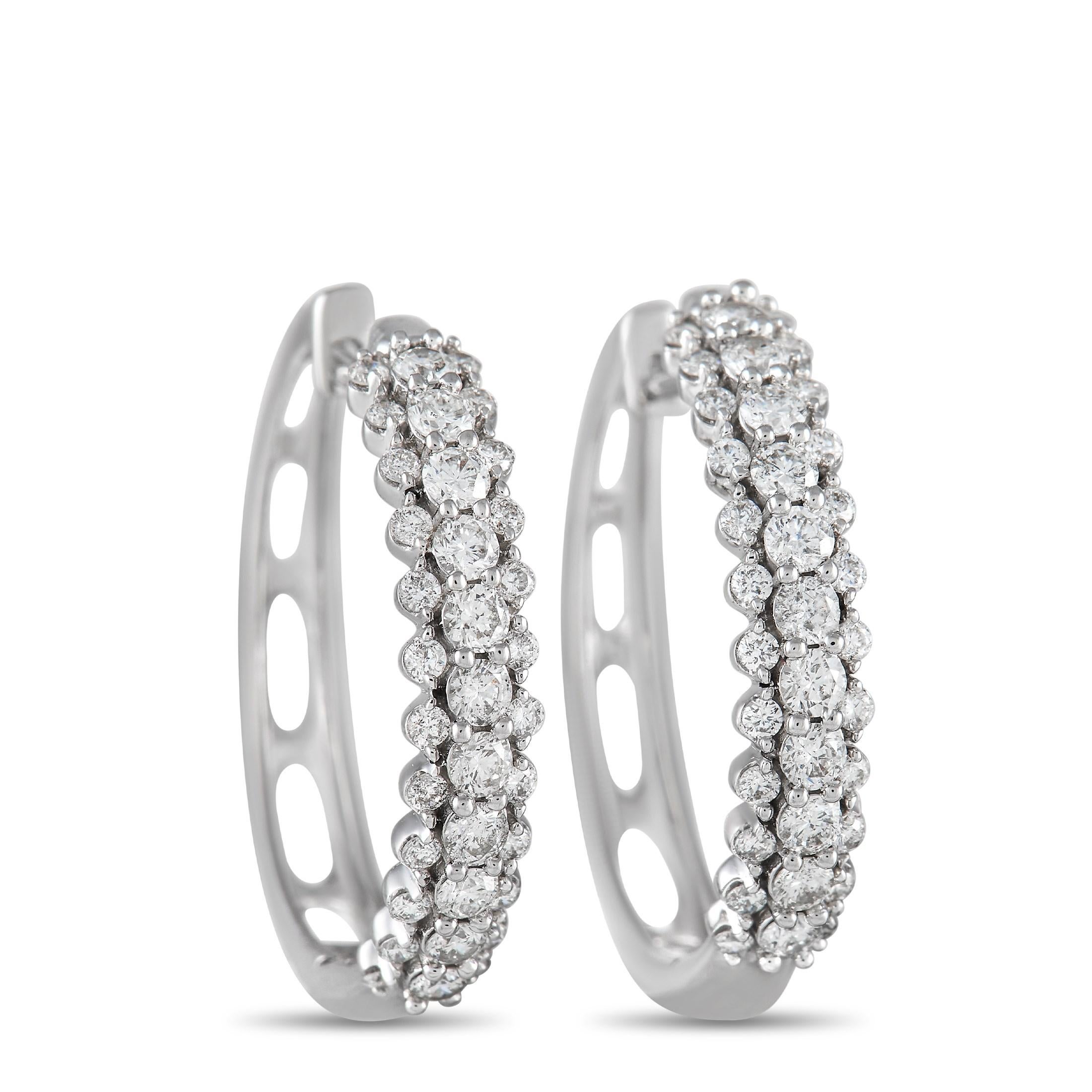 These chic 14K White Gold earrings are delightfully unexpected in design. Three rows of diamonds cover each of these delicate hoops, which measure 0.85” long and 0.75” wide – together they possess a total weight of 1.0 carats.  

This jewelry piece
