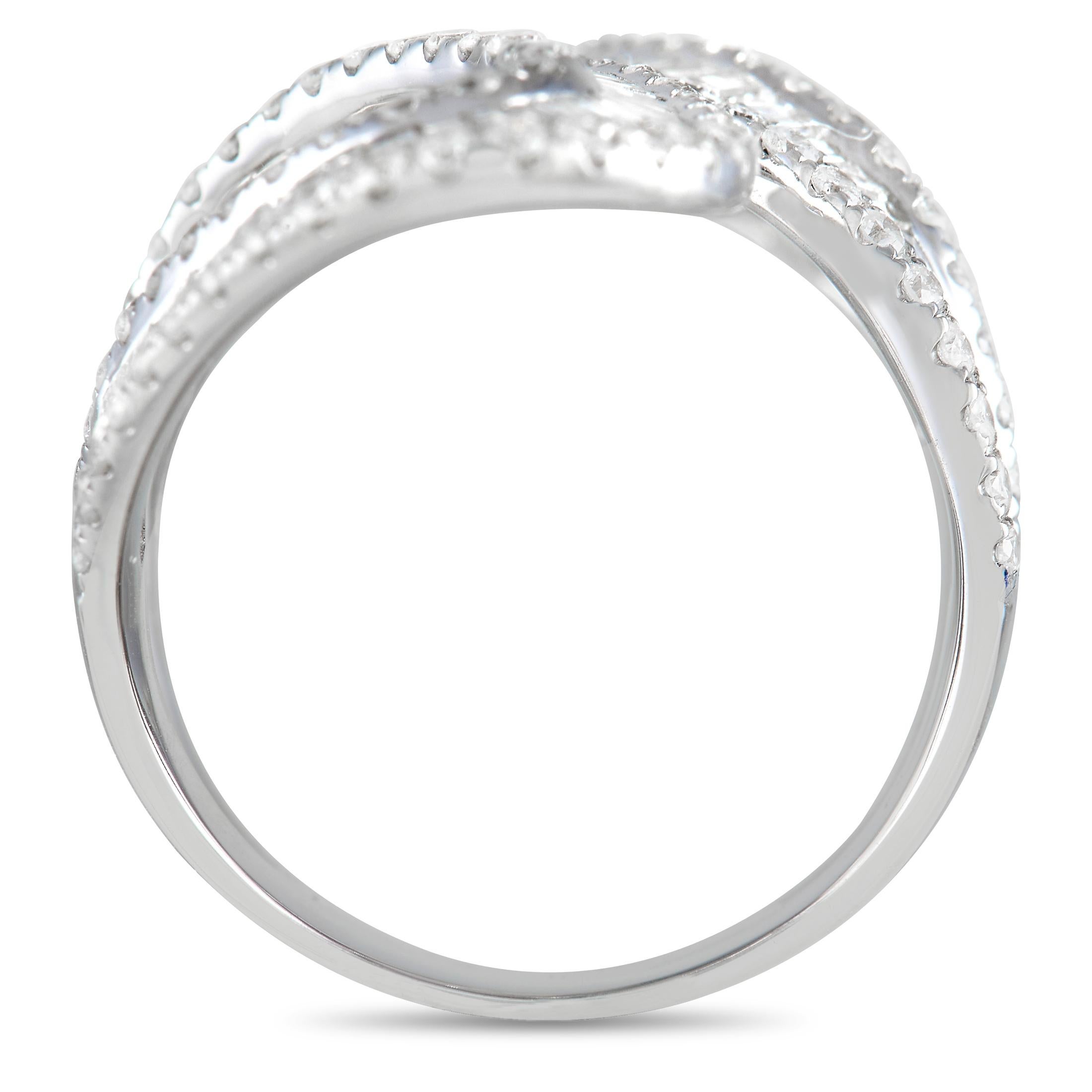 A mesmerizing addition to your jewelry collection. This diamond ring is fashioned from 14K white gold and is designed with a wide split-bypass shank. Looking like a glittering ribbon on the finger, the band has its swirly top covered entirely with