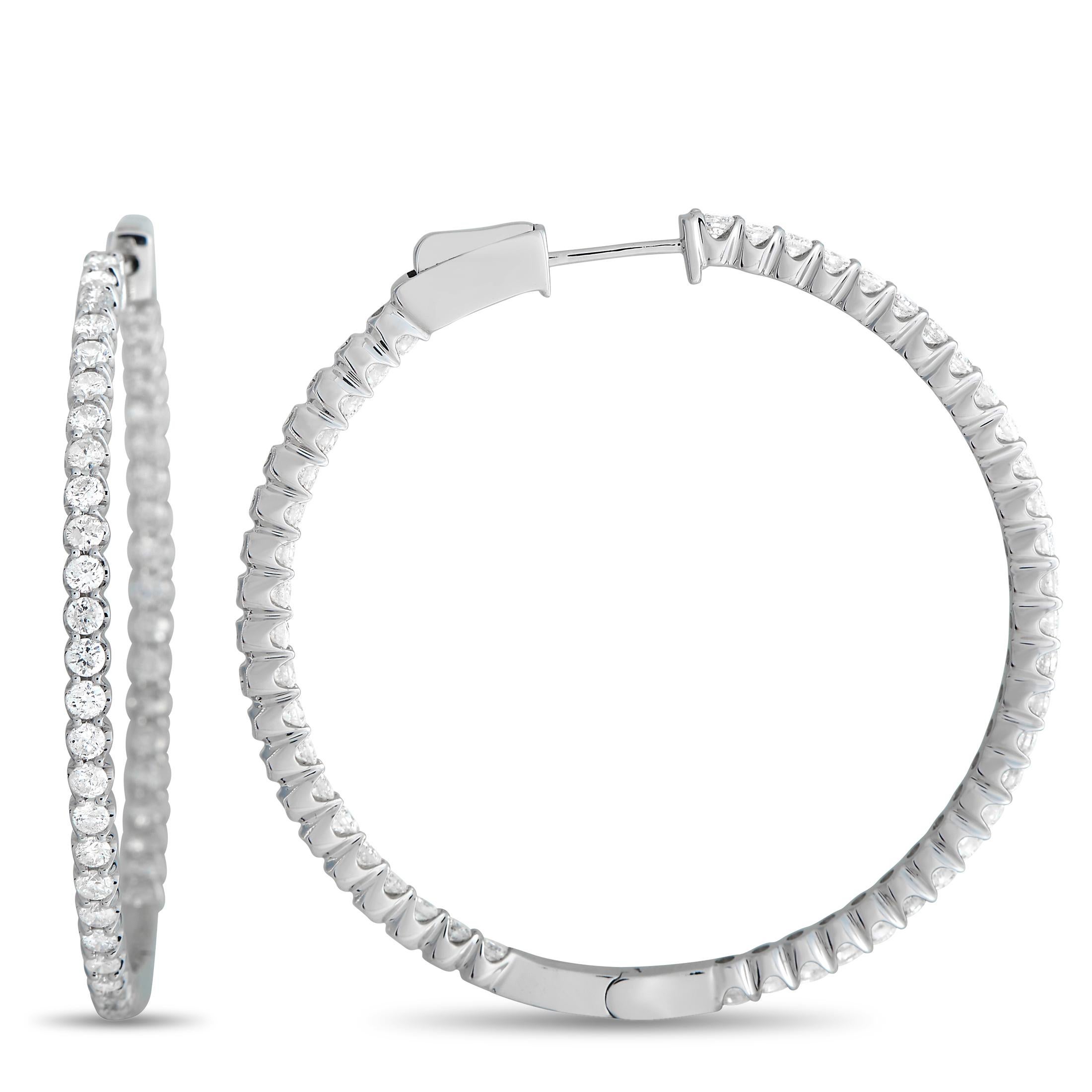 Sparkly and slim, these diamond-encrusted hoop earrings will instantly polish your outfits. Each hoop measures less than 2 inches in diameter and features a row of diamonds on its outer front surface and inner front-facing surface. 

This pair of LB