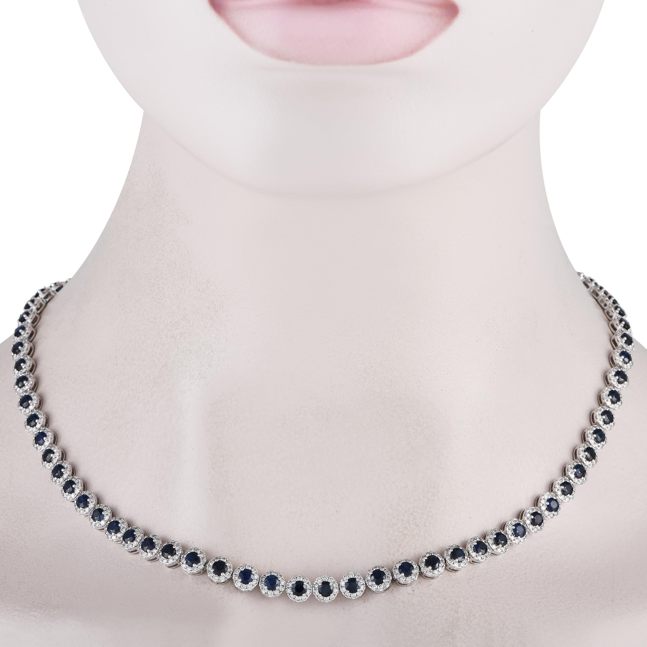 A series of round-cut sapphires with a total weight of 13.50 carats add color and dimension to this simple, elegant necklace. Crafted from shimmering 14K White Gold, each sapphire stone is accented by a halo of diamond accents that together possess