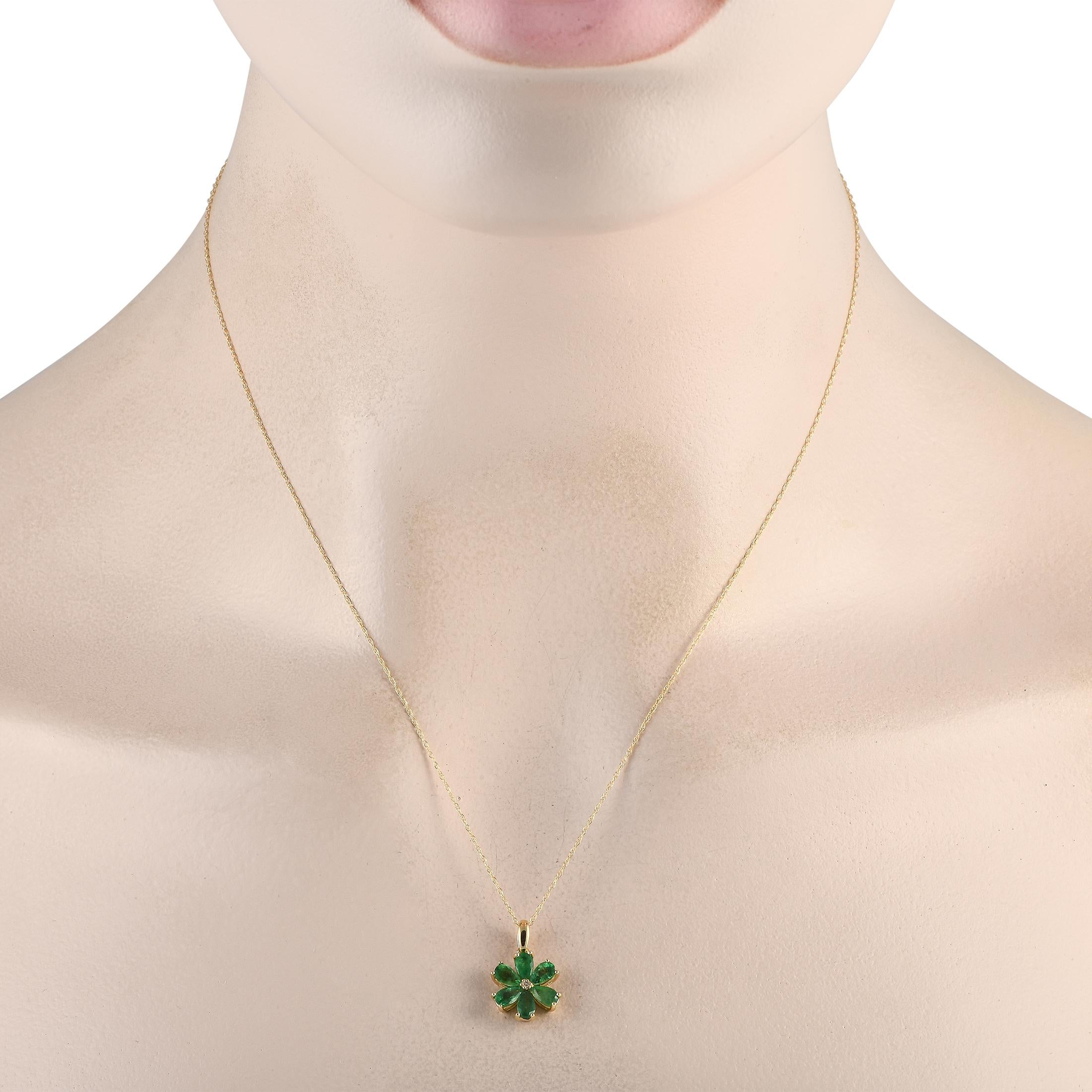 A floral shaped pendant makes a statement on this simple, elegant necklace. Crafted from 14K yellow gold, the pendant comes to life thanks to radiant emerald petals and a single 0.01 carat diamond stone at the center. It measures 0.75 long by 0.50