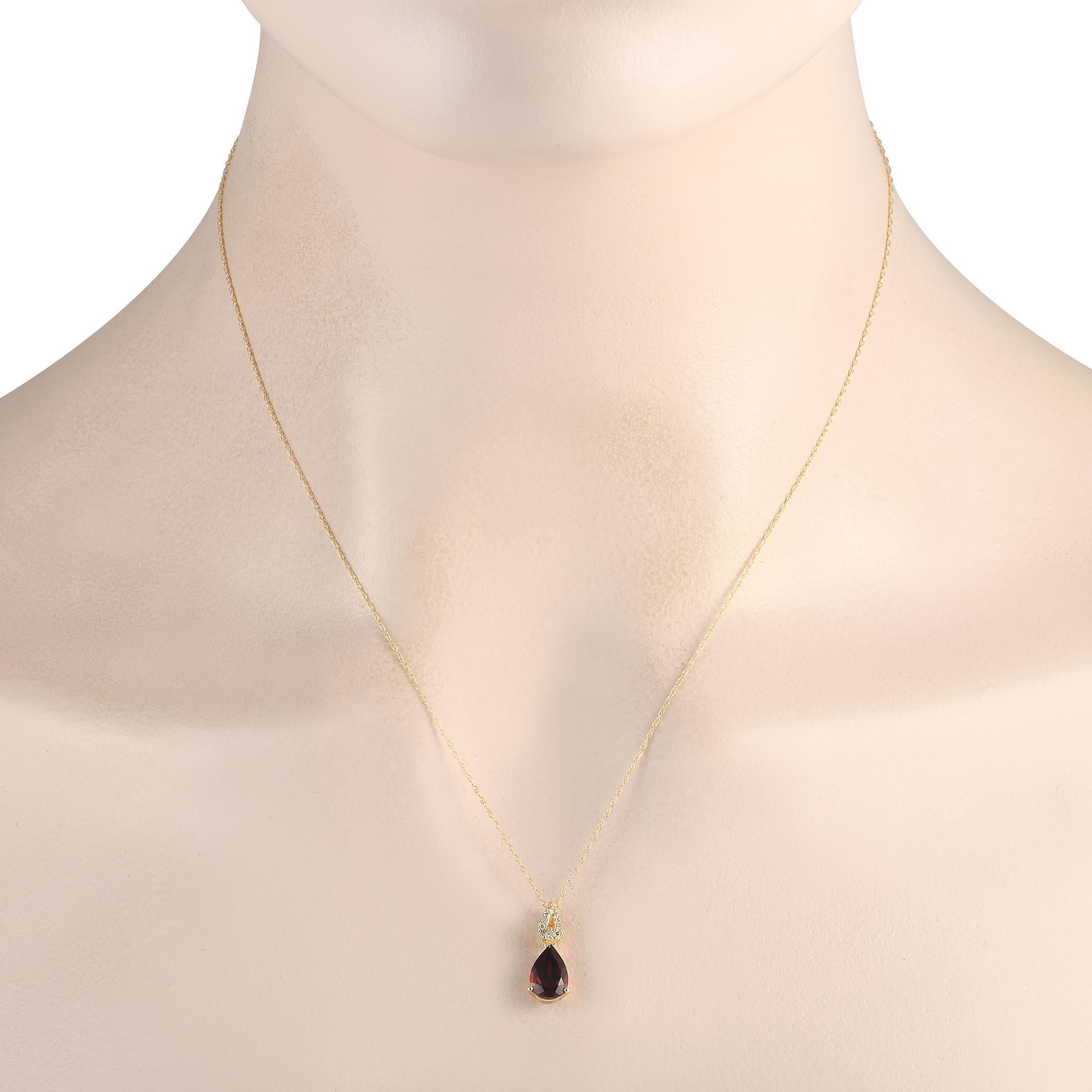 Add a touch of luxury to any occasion with this exquisite necklace. Sleek and simple, the 14K Yellow Gold pendant beautifully showcases Diamond accents totaling 0.06 carats and a deep red pear-shaped Garnet gemstone. The pendant measures 0.65 long