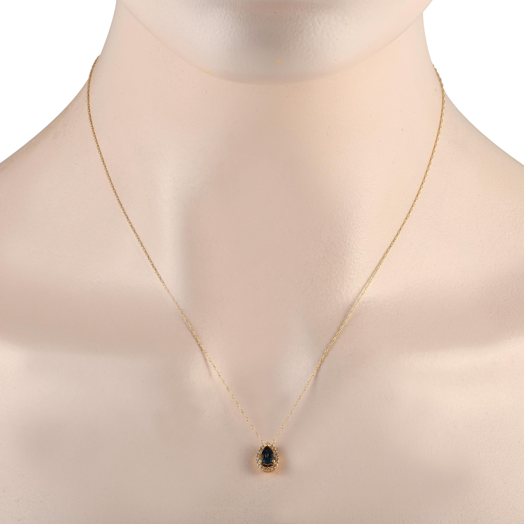 Want to add a touch of drama to your dressy looks? Wear this diamond and blue topaz necklace. It comes with a dainty 14K yellow gold cable chain with a spring ring clasp. The pear-shaped pendant has its outline traced with petite round diamonds. At