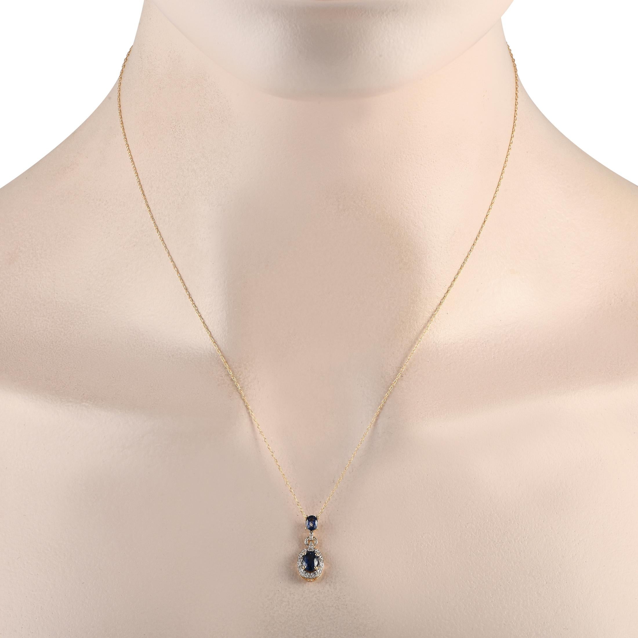 Elevate the glam factor of a cocktail attire with this diamond and sapphire necklace. It has the perfect combination of brilliance and sophistication, thanks to the two oval sapphires and the diamond halos. The pendant measures less than an inch in