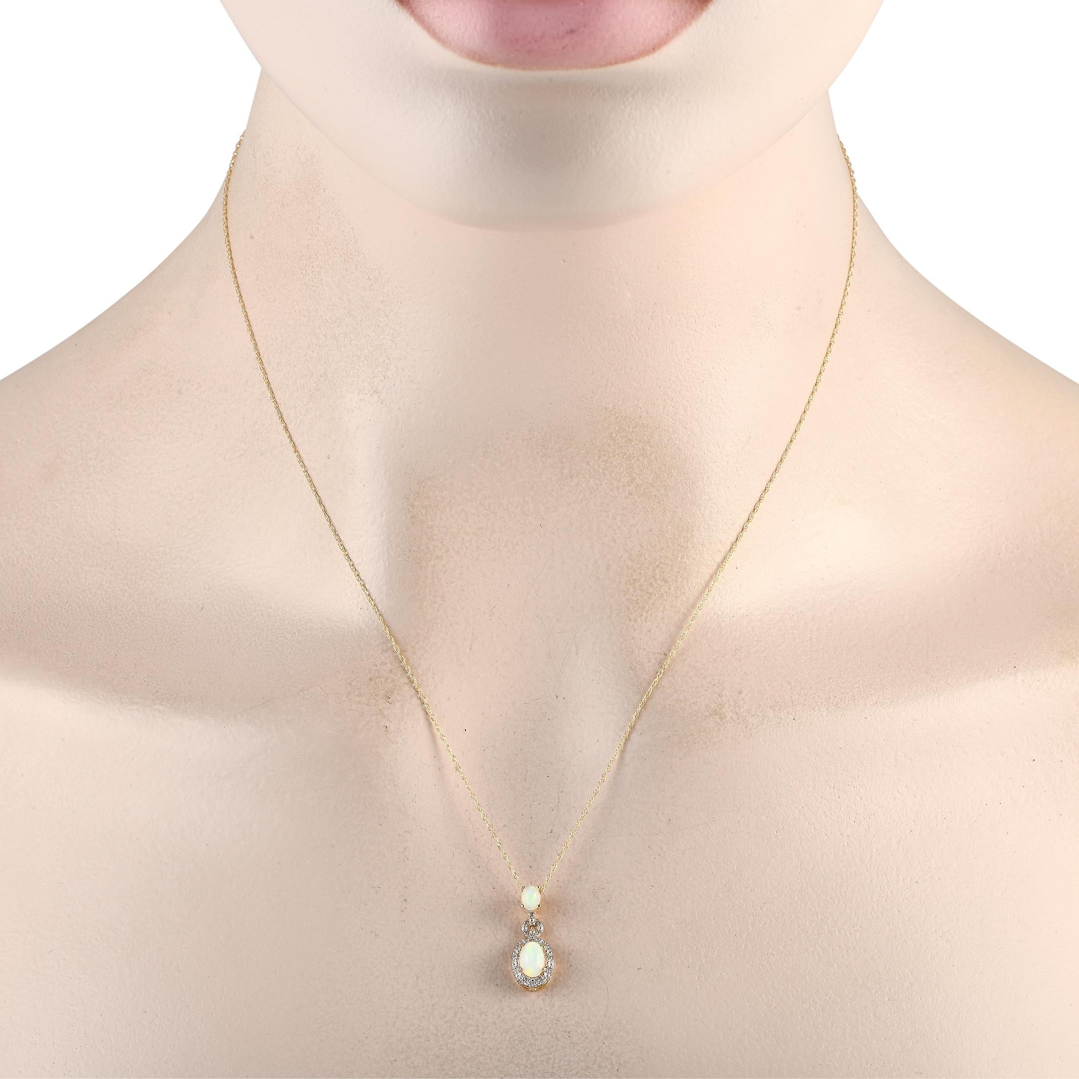 This luxurious necklace is incredibly sophisticated. Suspended from an 18 chain, youll find an elegant 14K yellow gold pendant measuring 0.75 long by 0.25 wide. A pair of radiant opals elevate this dynamic design, while sparkling diamonds totaling