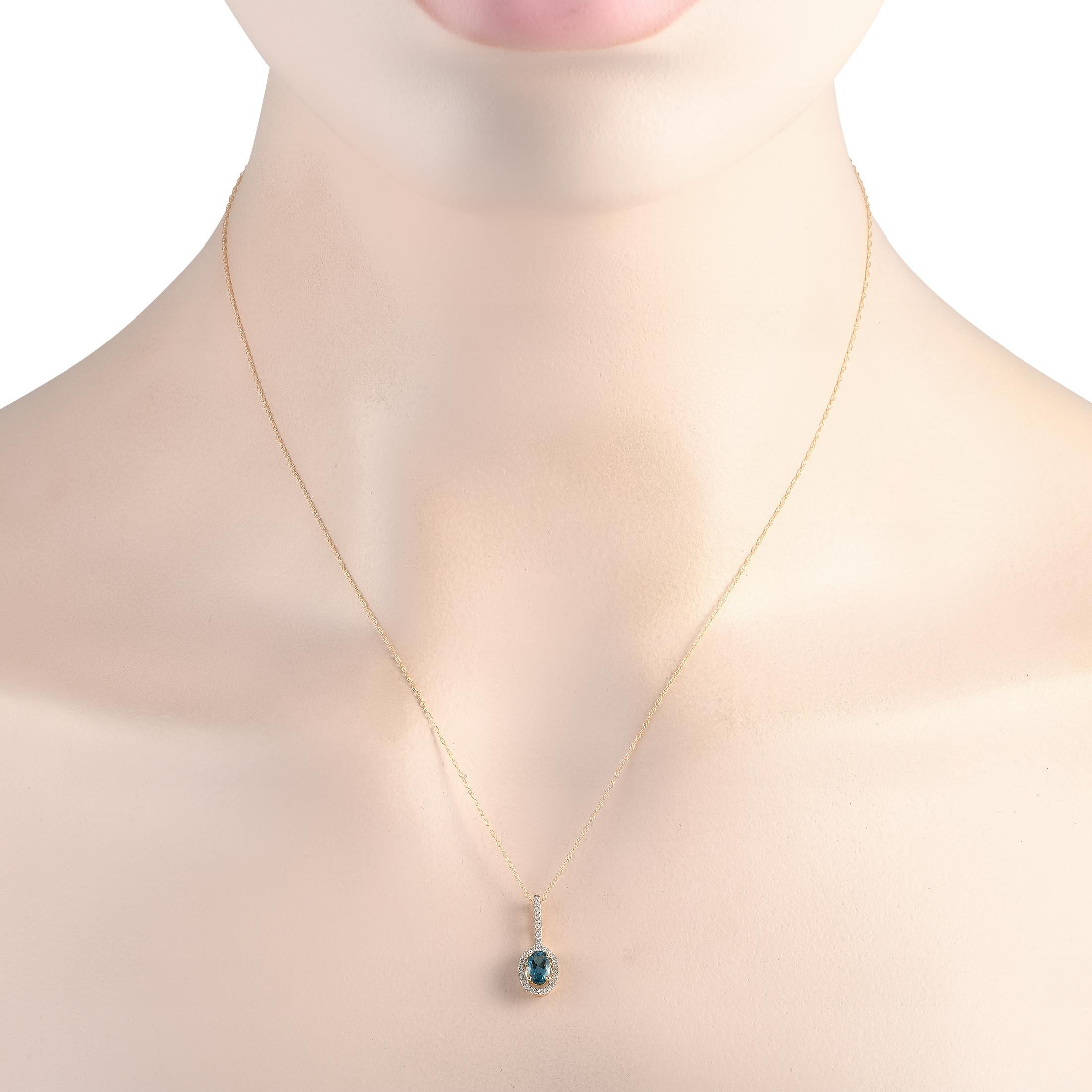 Add luxury to your daily style with this diamond and blue topaz necklace. It is crafted in 14K yellow gold, with a double cable chain measuring 18 inches long. The bail shimmers with petite round diamonds, complementing the oval frame surrounding