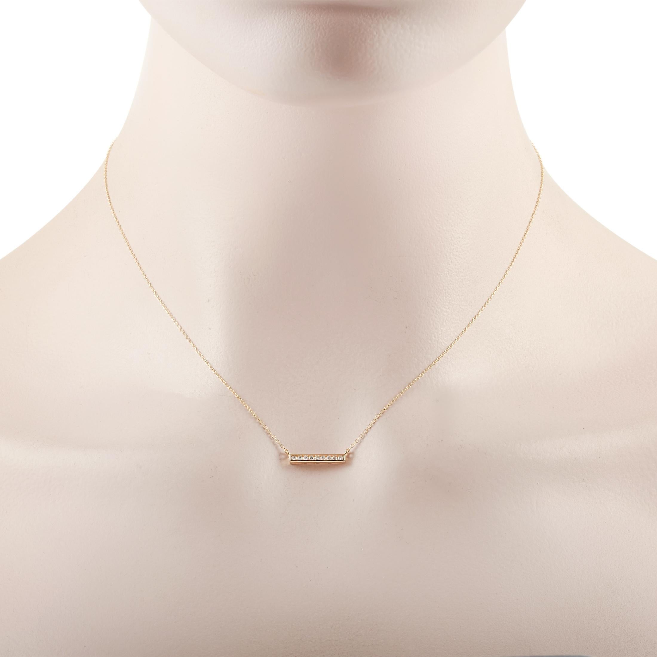 This LB Exclusive necklace is crafted from 14K yellow gold and weighs 1.6 grams. It is presented with a 15” chain and boasts a pendant that measures 0.13” in length and 0.50” in width. The necklace is set with diamonds that total 0.10 carats.
 
