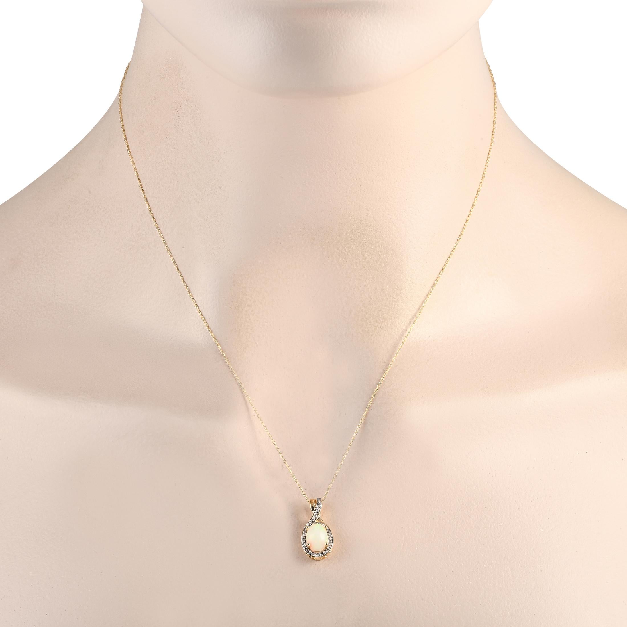 A radiant Opal gemstone shines to life on this exquisite necklace. This pieces stylish pendant features a 14K Yellow Gold setting that measures 0.75 long by 0.45 wide. Its suspended from an 18 chain and includes inset Diamond accents totaling 0.11