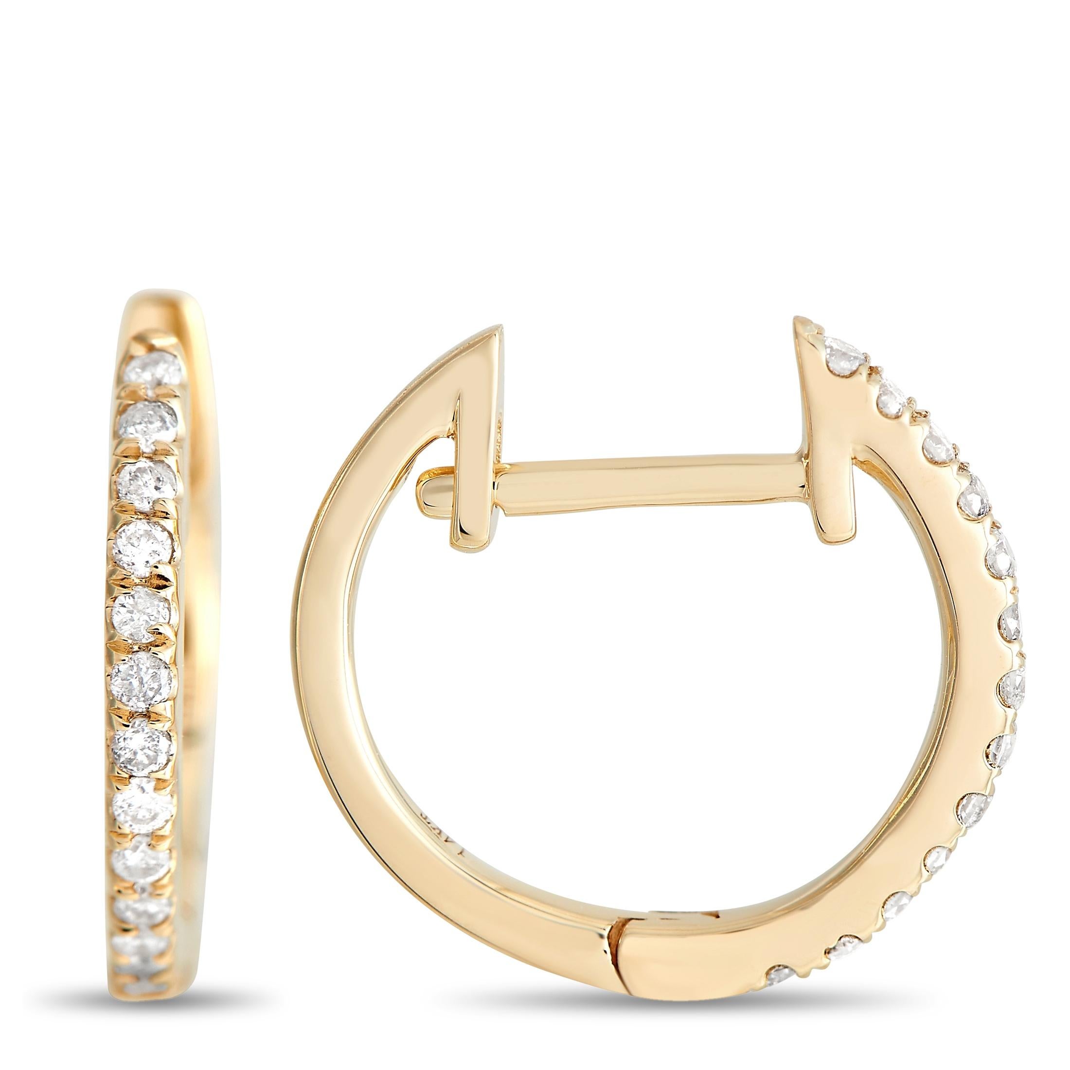 These understated hoop earrings are ideal for everyday wear. Each one measures 0.5” long, 0.10” wide, and is crafted from 14K Yellow Gold, which beautifully showcases the elegant array of diamonds totaling 0.12 carats. 
 
 This jewelry piece is