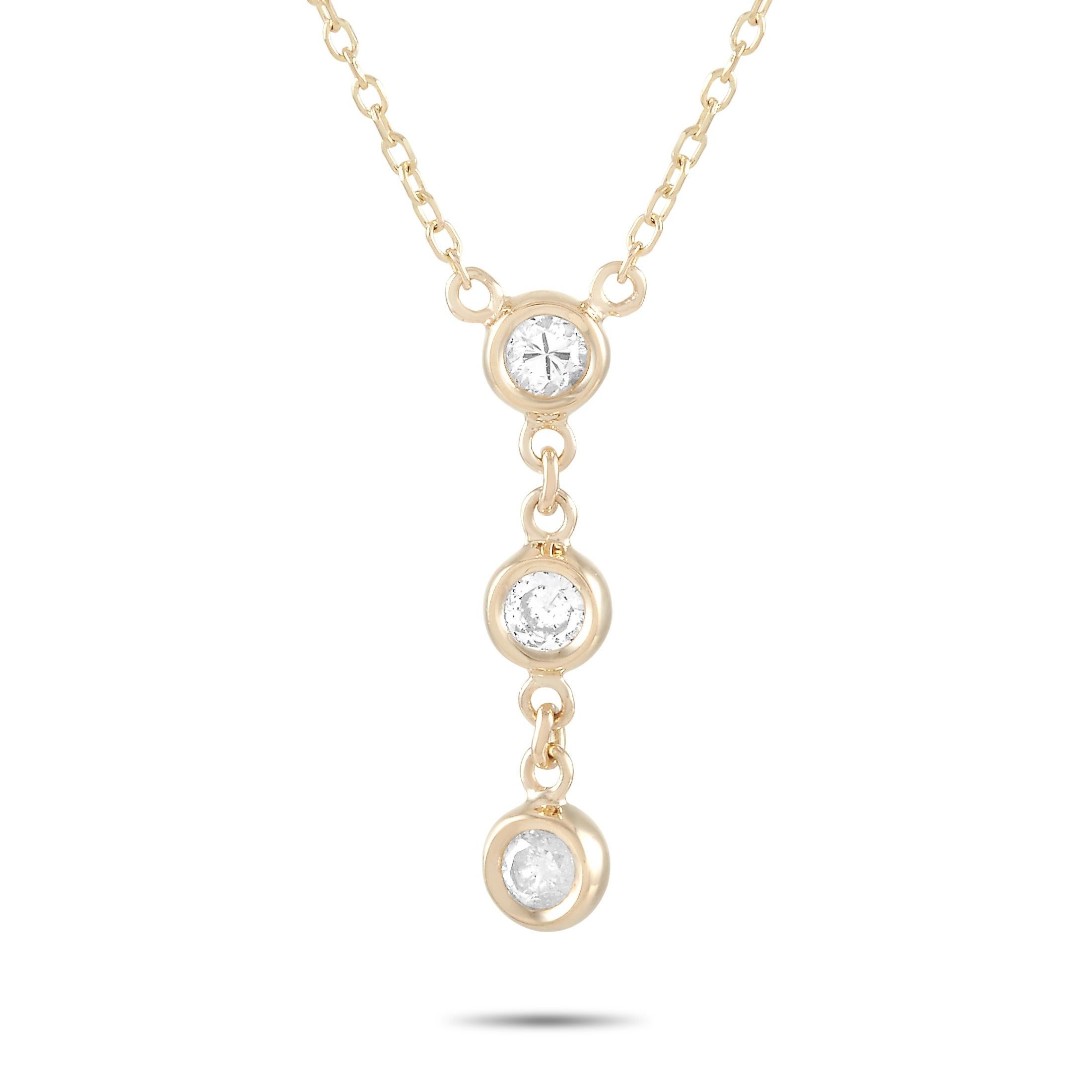 This LB Exclusive necklace is crafted from 14K yellow gold and weighs 1.4 grams. It is presented with a 15” chain and boasts a pendant that measures 0.68” in length and 0.13” in width. The necklace is set with diamonds that total 0.15