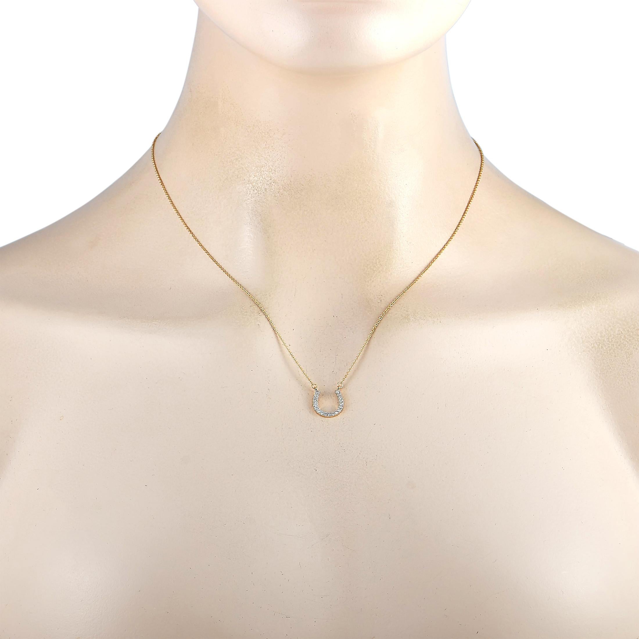 This LB Exclusive necklace is made of 14K yellow gold and embellished with diamonds that amount to 0.20 carats. The necklace weighs 2 grams and is presented with a 16” chain and a horseshoe pendant that measures 0.50” in length and 0.47” in