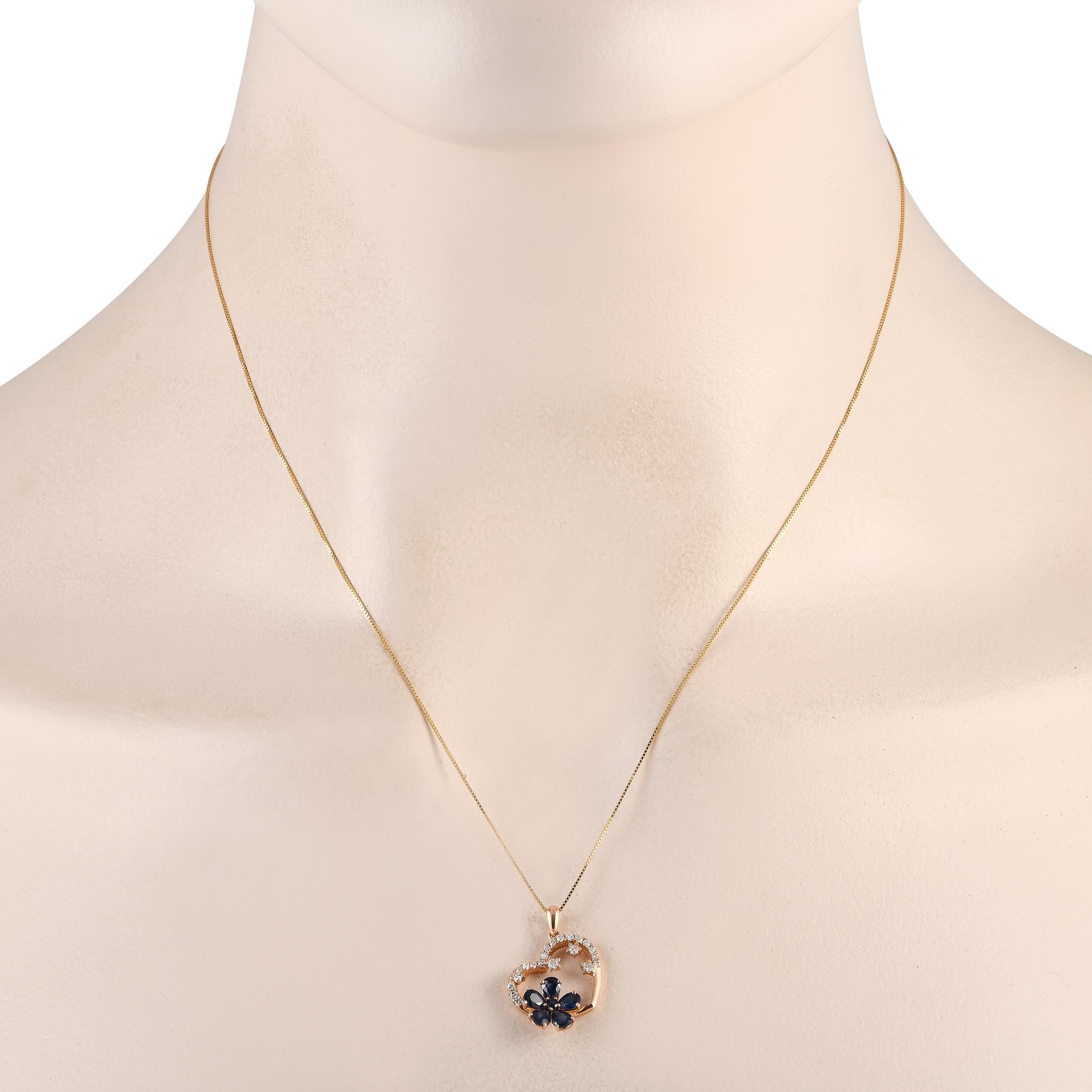 A charming heart-shaped pendant makes a statement on this luxurious necklace. Crafted from opulent 14K Yellow Gold, the pendant measures 0.85 long by 0.65 wide and is suspended from an 18 chain. Its adorned with a floral motif accented with Sapphire