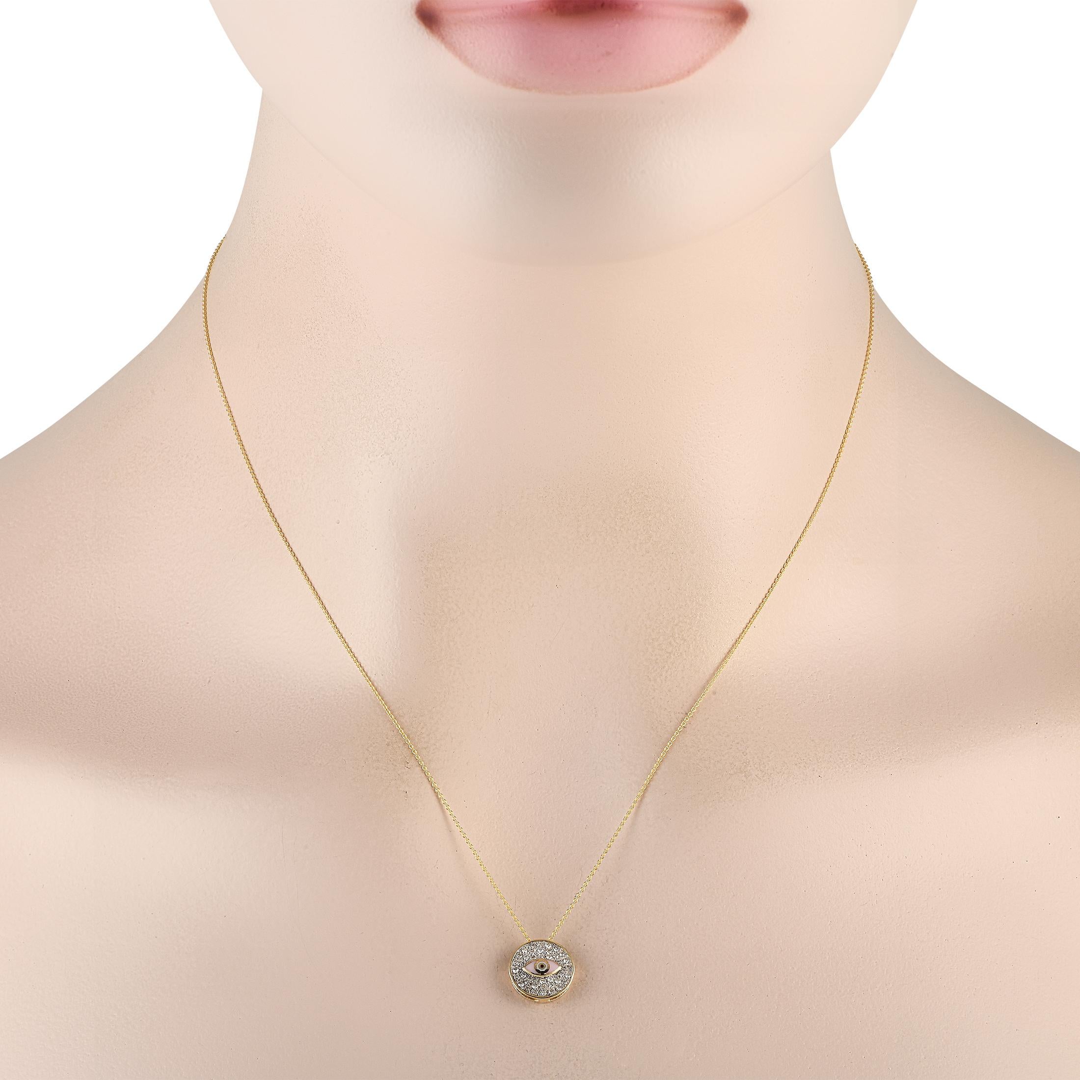 At the center of this necklaces round pendant, an exquisite eye accent serves as a stunning focal point. Crafted from 14K Yellow Gold, the pendant measures 0.45 round and comes to life thanks to inset diamonds totaling 0.20 carats. This piece
