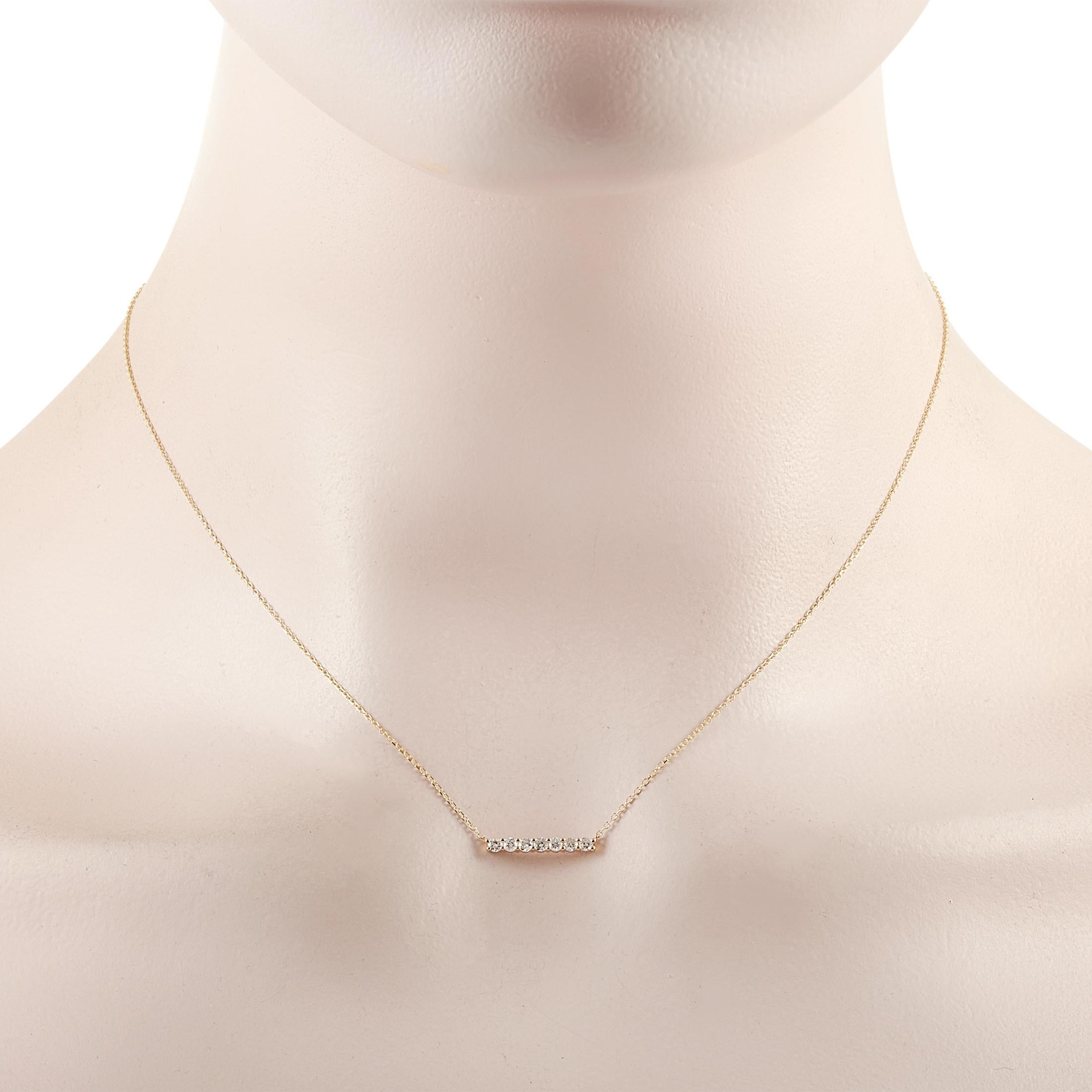This LB Exclusive necklace is crafted from 14K yellow gold and weighs 1.4 grams. It is presented with a 15” chain and boasts a pendant that measures 0.13” in length and 0.50” in width. The necklace is set with diamonds that total 0.25 carats.
 
