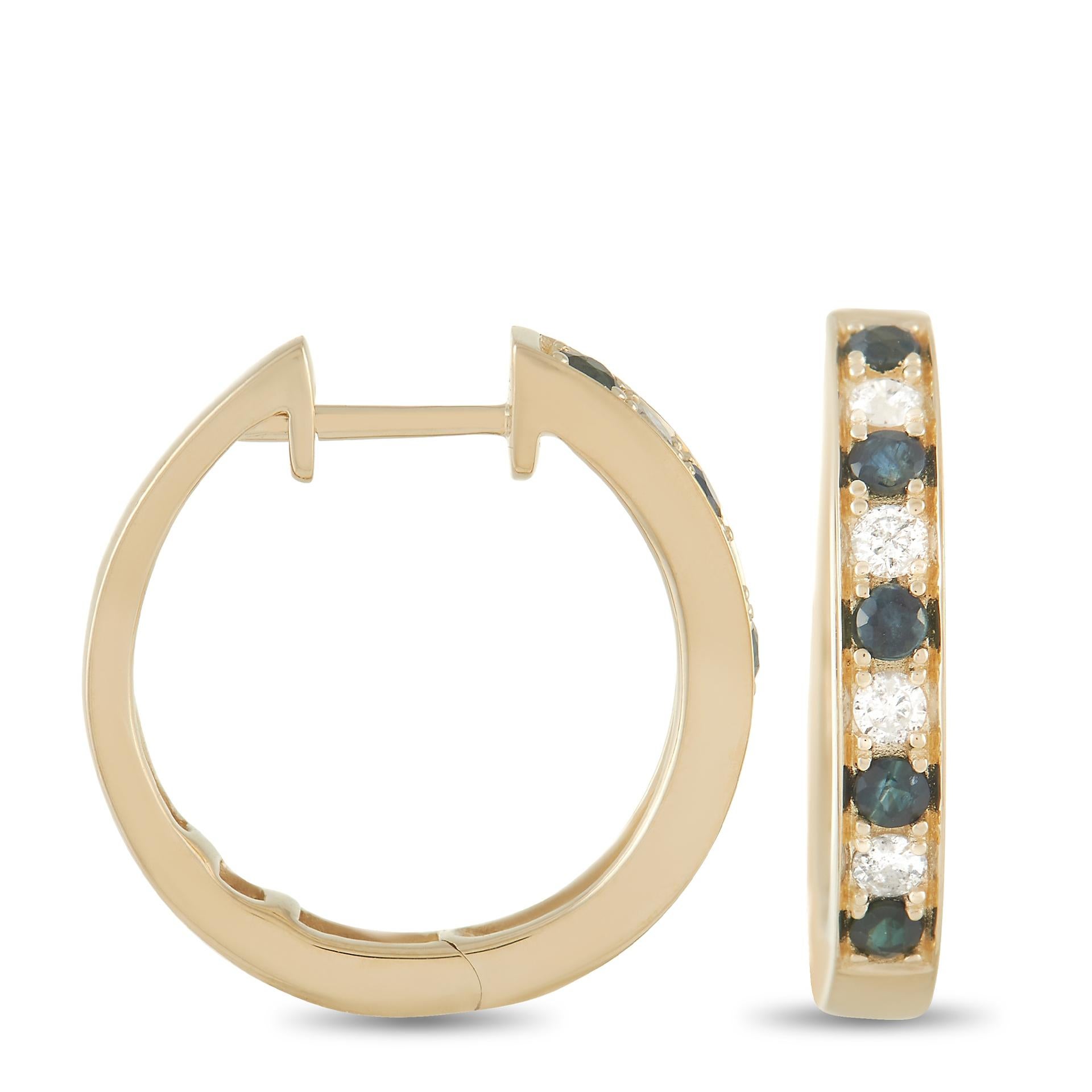 An opulent 14K Yellow Gold setting provides the perfect backdrop for shimmering gemstones on these luxurious hoop earrings. Each one measures 0.63” round and features 0.25 carats of diamonds alternating with 0.42 carats of deep blue sapphires. 
  
 