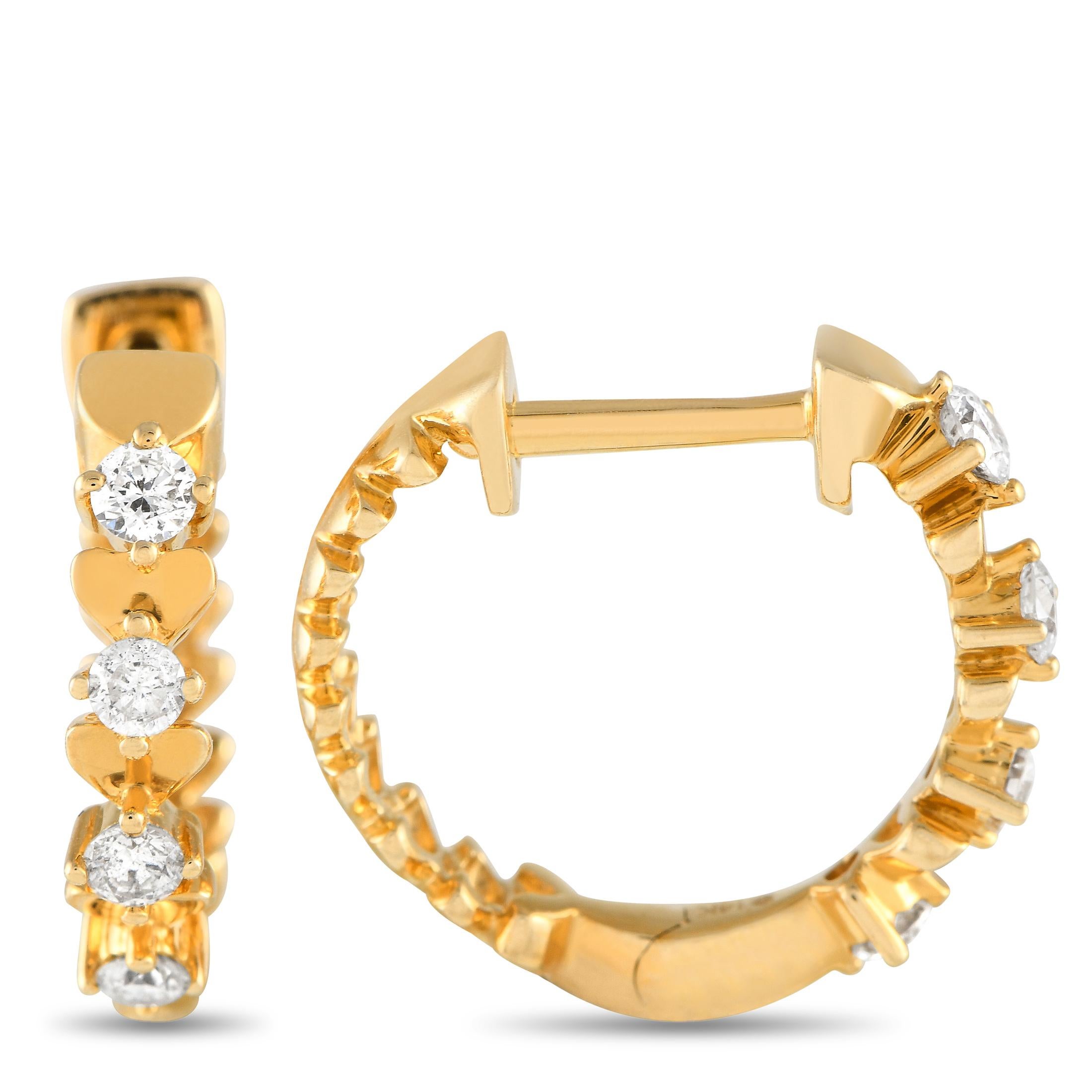 Diamonds with a total weight of 0.25 carats make these hoop earrings simply unforgettable. Each one of these elegant earrings features a bold 14K Yellow Gold setting measuring 0.65 round that features subtle heart motifs.This jewelry piece is