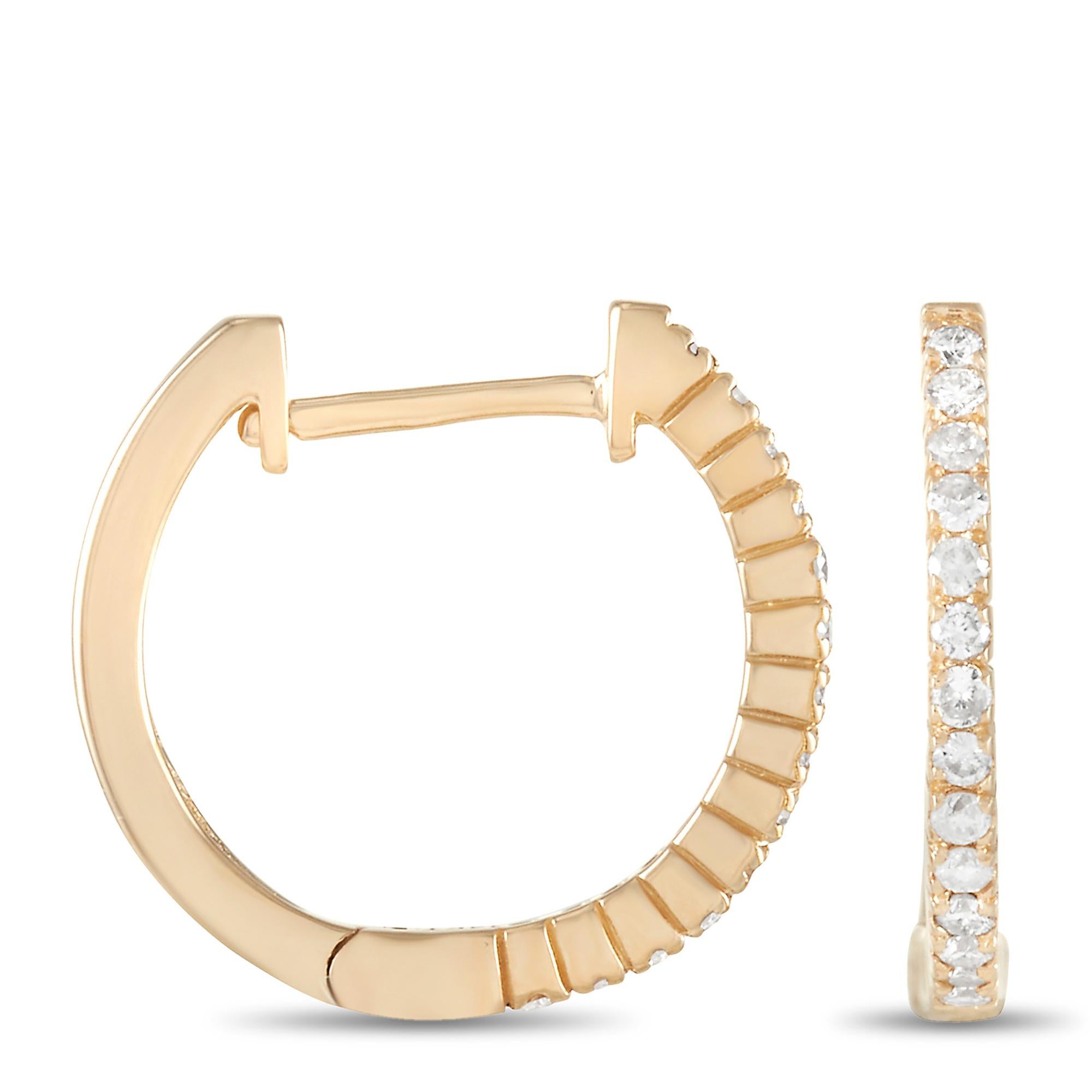 These diamond hoop earrings have undeniable charm. Measuring 0.57 inches round, each hoop comes to life thanks to a row of glittering gemstones set within a classic 14K yellow gold setting. Together they feature a total weight of 0.27 carats and