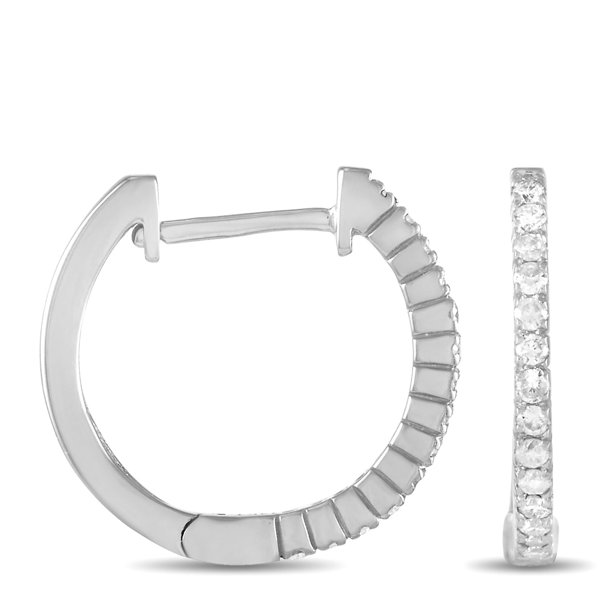These diamond hoop earrings have undeniable charm. Measuring 0.57 inches round, each hoop comes to life thanks to a row of glittering gemstones set within a classic 14K white gold setting. Together they feature a total weight of 0.27 carats and