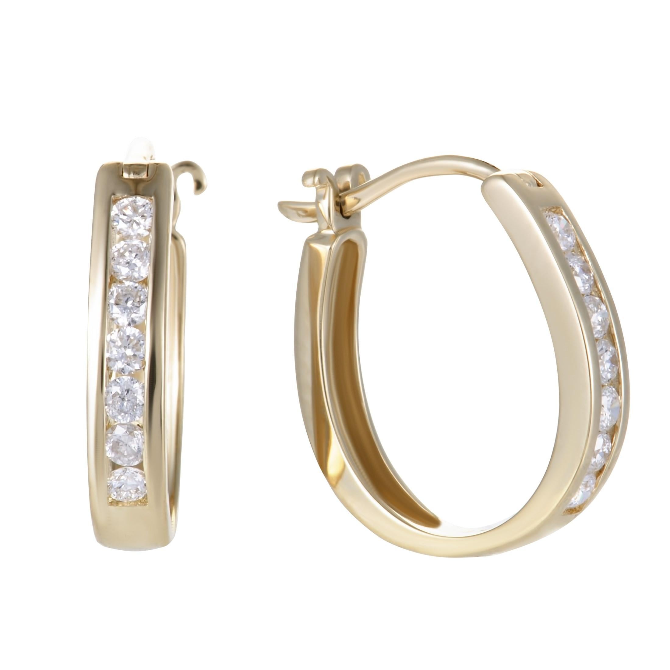 With a design that is both subtle and attractive, these superb hoop earrings offer a look of exceptional class and femininity. Made of 14K yellow gold, the pair weighs 2.6 grams and is set with diamonds that total 0.33 carats.
