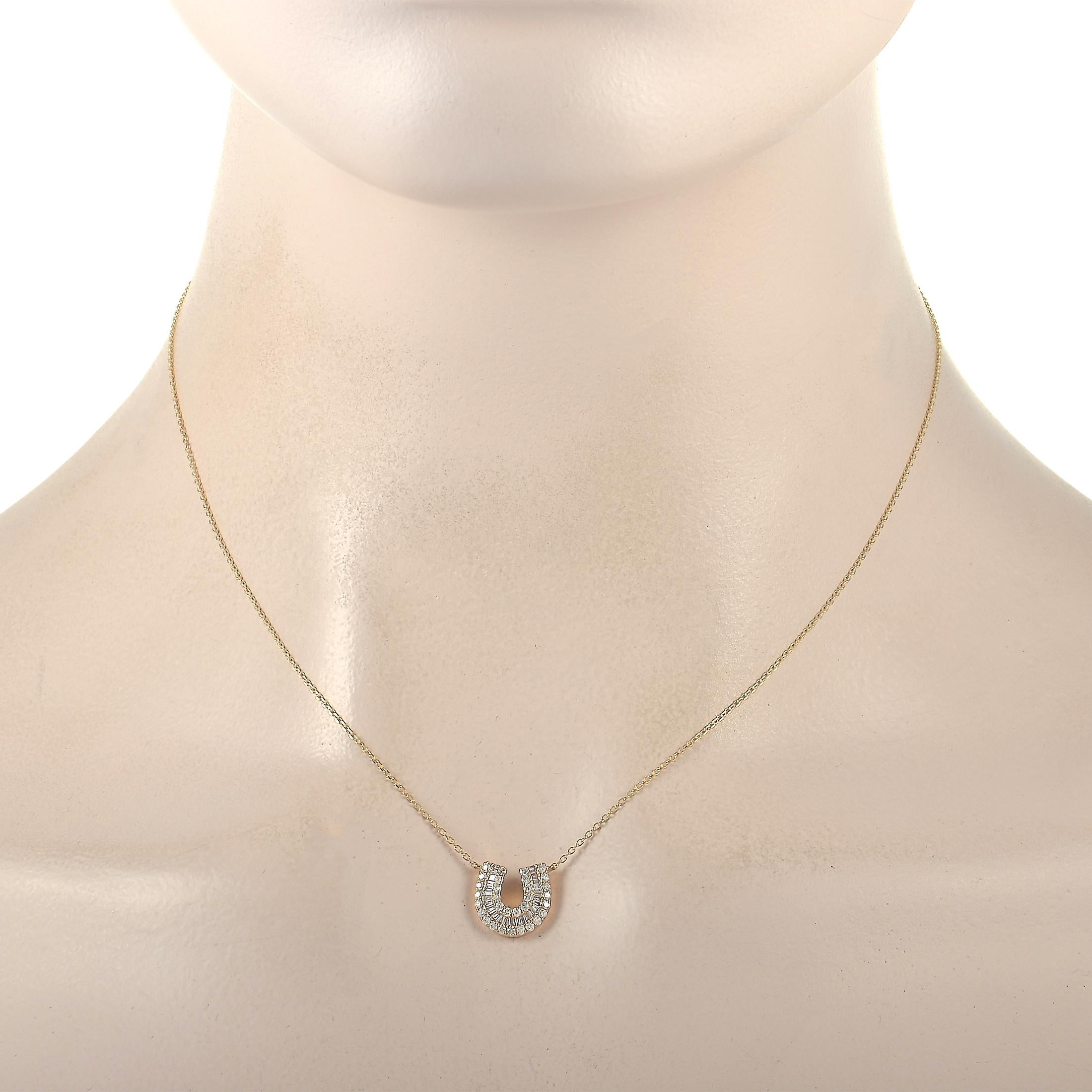 This elegant LB Exclusive 14K Yellow Gold 0.45 ct Diamond Horseshoe Necklace is made with a delicate 14K yellow gold chain, highlighting a horseshoe pendant. The pendant is set with two rows of round diamonds flanking and a row of baguette diamonds