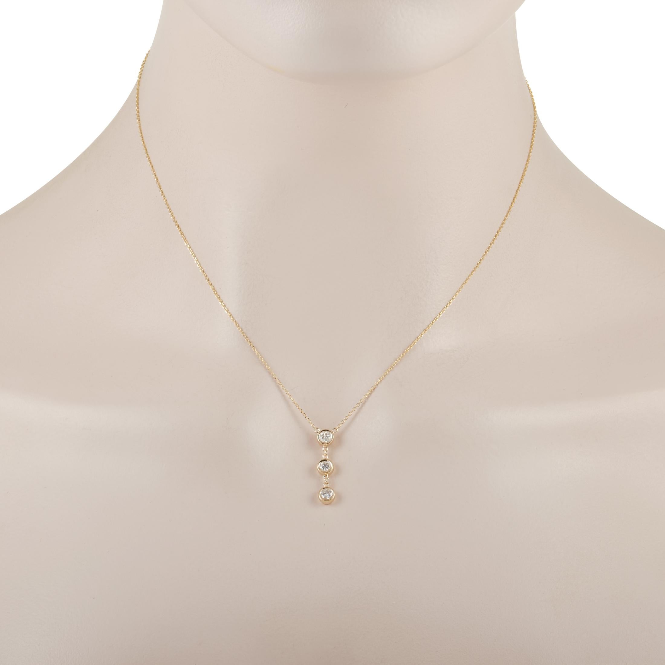 Glittering diamonds and 14K Yellow Gold pair together beautifully on this contemporary pendant necklace. The sleek, streamlined pendant - which measures .75” long and .19” wide - adds just a hint of thanks to the presence of three bezel-set diamonds