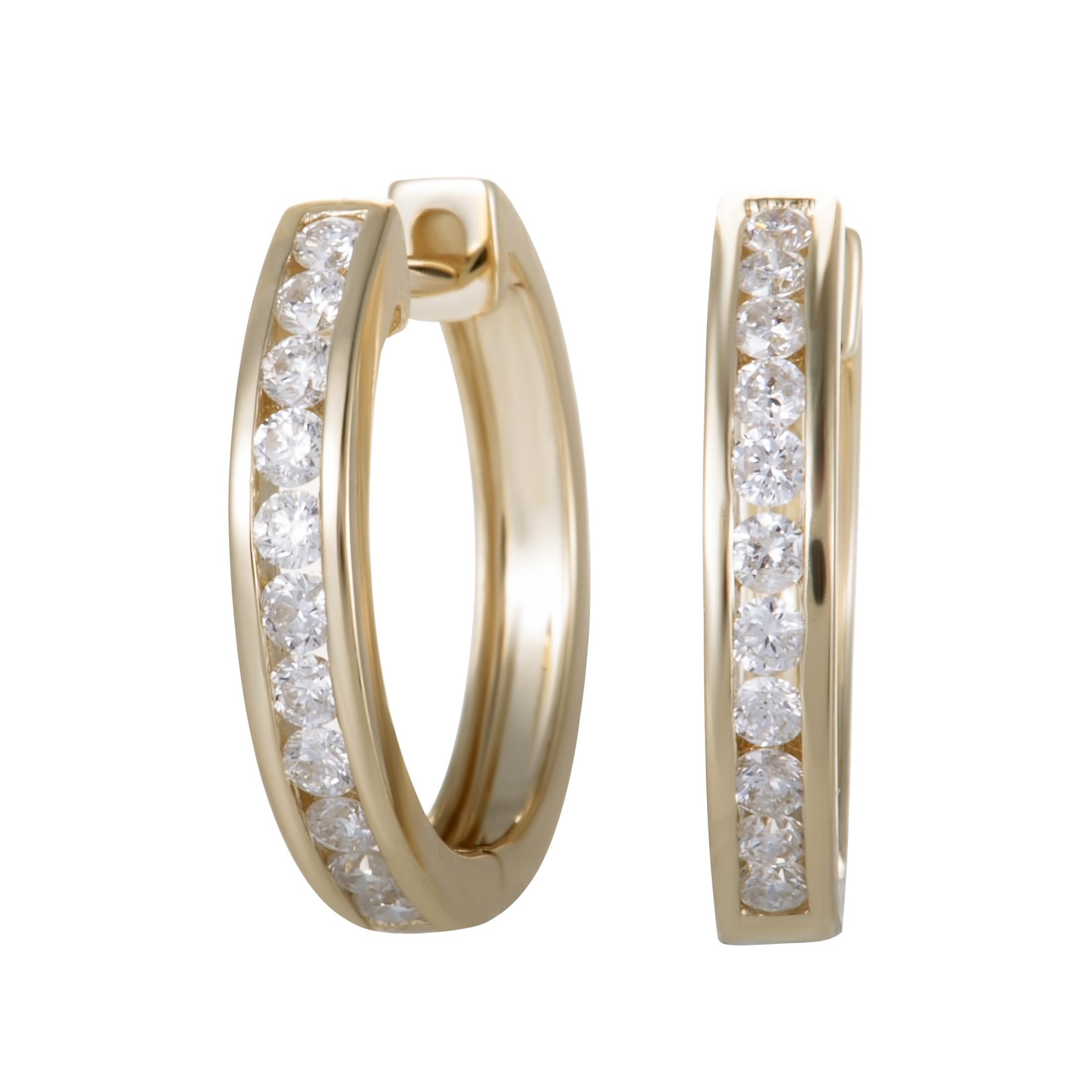 Combining the alluring radiance of 14K yellow gold with the glamorous brilliance of diamond stones, these lovely hoop earrings offer an exceptionally elegant look. The pair weighs 2.9 grams and the diamonds total 0.50 carats.