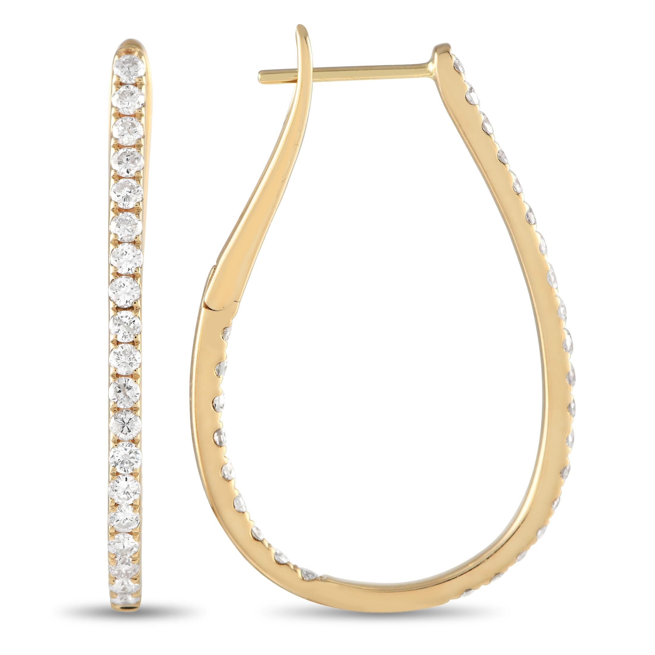 These earrings are truly timeless in design. Diamonds with a total weight of 2.0 carats make them a luxury piece that will continually catch the light. Each one is crafted from 14K yellow gold and measures 1.15 long by 1.0 wide.This jewelry piece is