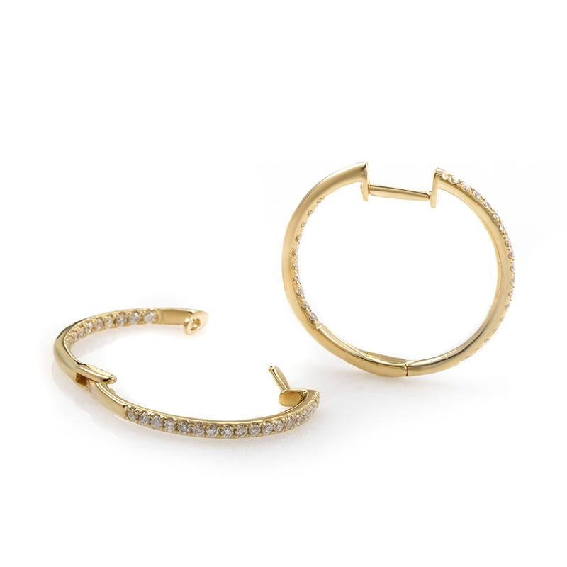 A stylish, prestigious-looking pair of hoop earrings splendidly made from 14K yellow gold, set on frontally visible sides with gleaming diamond stones totaling 0.51ct.
