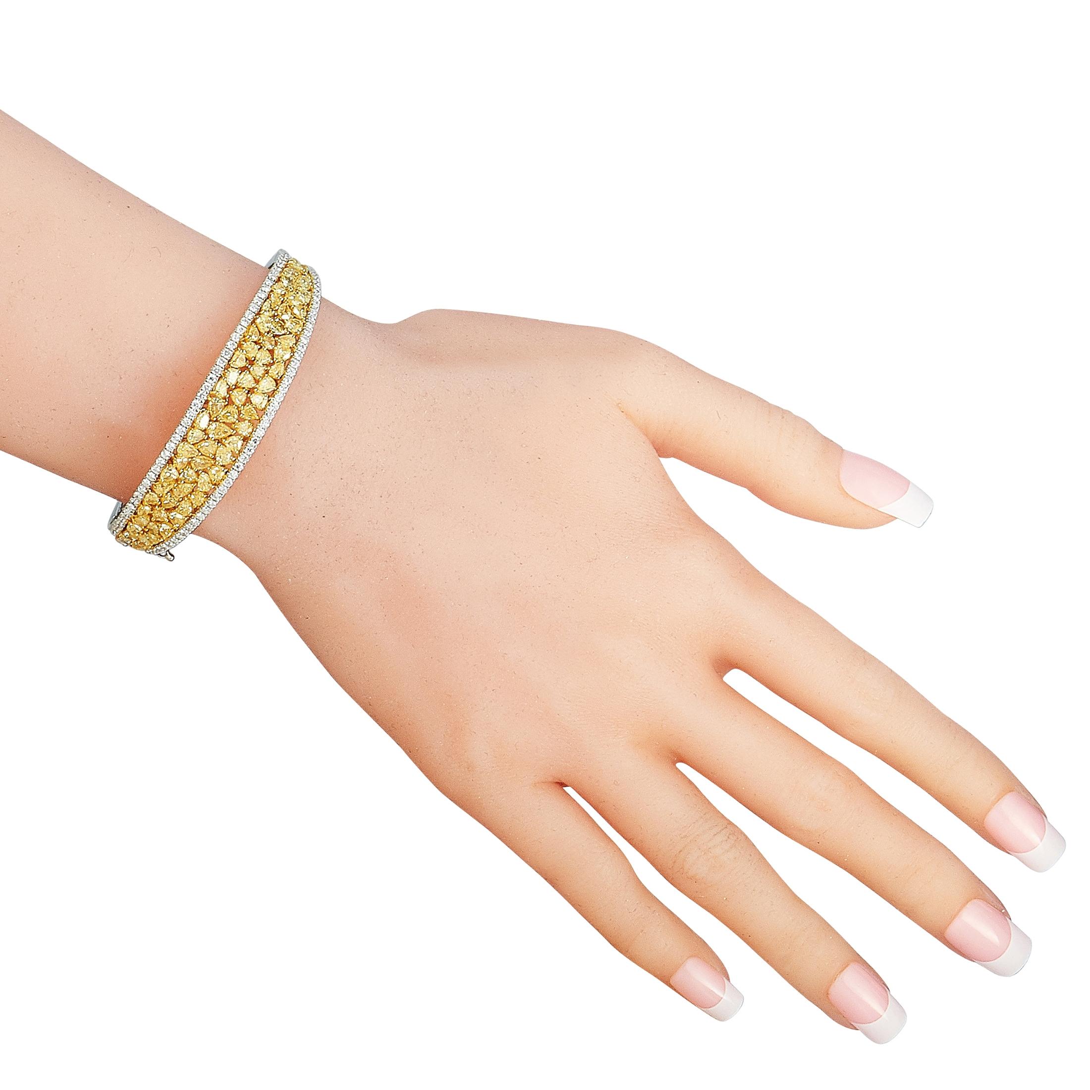 This LB Exclusive bracelet is made of 18K white gold and embellished with white and yellow diamonds that total 1.79 and 9.21 carats respectively. The bracelet weighs 31 grams and measures 7” in length.

Offered in brand new condition, this jewelry