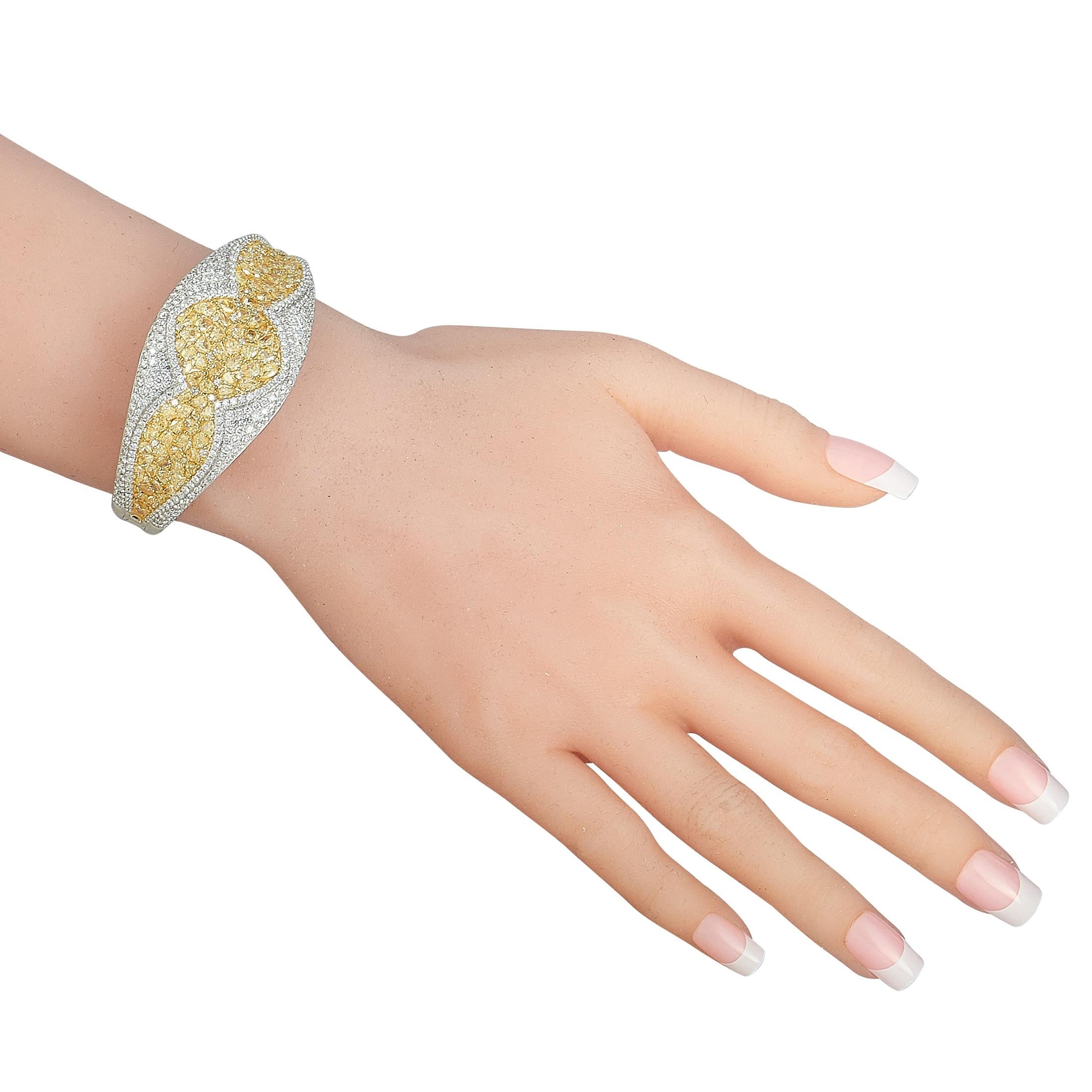 This LB Exclusive bracelet is made of 18K white gold and embellished with white and yellow diamonds that total 6.17 and 11.93 carats respectively. The bracelet weighs 53 grams and measures 7” in length.

Offered in brand new condition, this jewelry