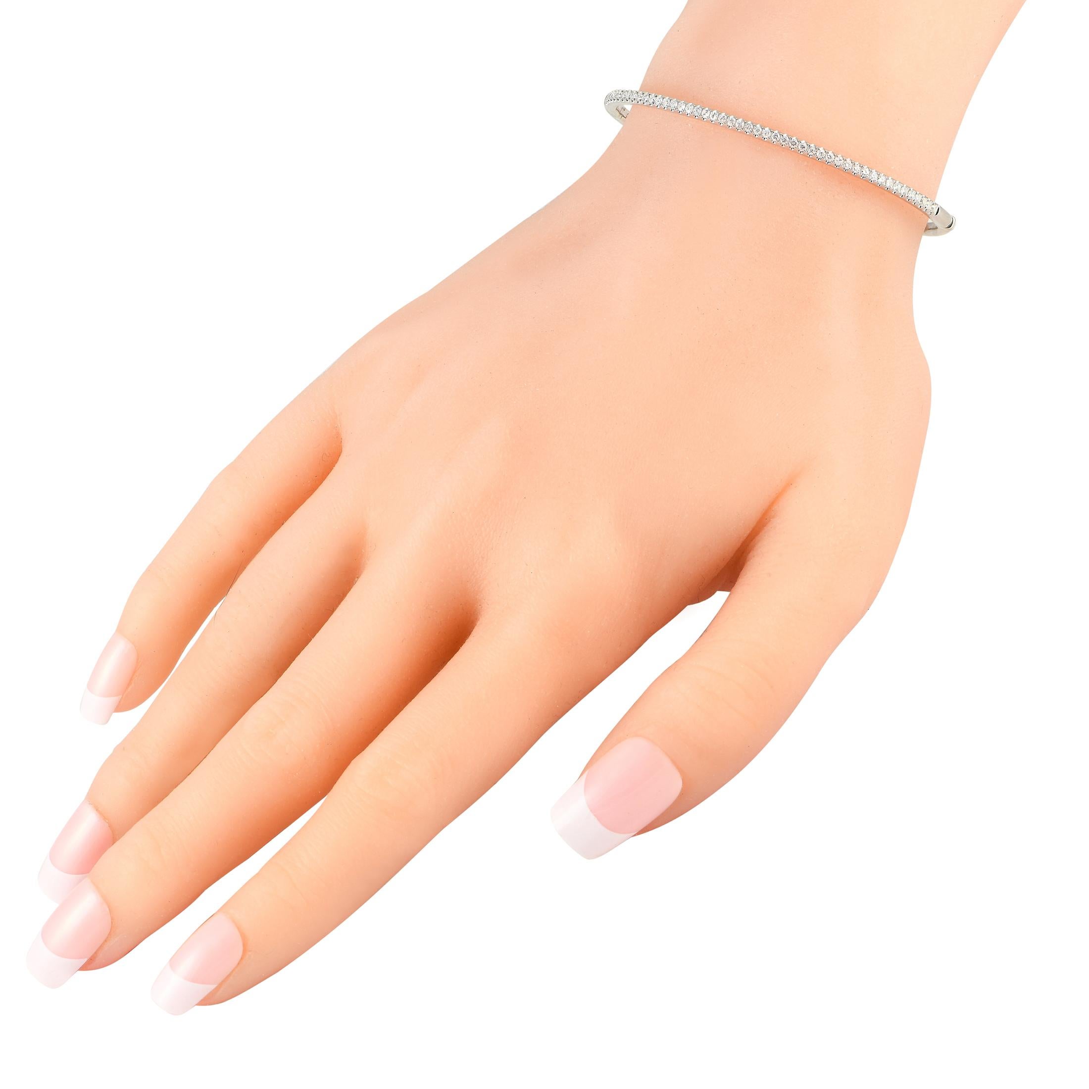 With a slim silhouette and understated sparkle, you can wear this bracelet with anything and everything for an effortlessly chic look. The sleek and slender bangle in solid 18K white gold has petite round diamonds running along half of its
